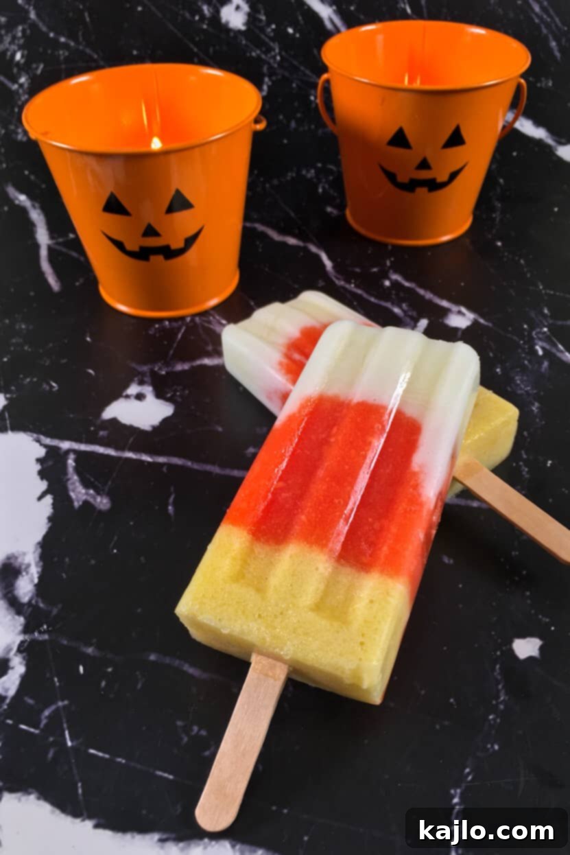 A close-up shot of a refreshing, naturally sweet papaya popsicle, highlighting its smooth texture and vibrant color, with no added sugar.