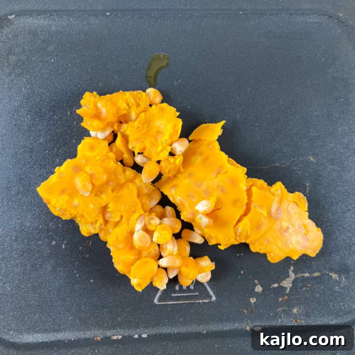 Air Fryer Magic for Microwave Popcorn 3 Microwave popcorn kernels placed in air fryer drip pan