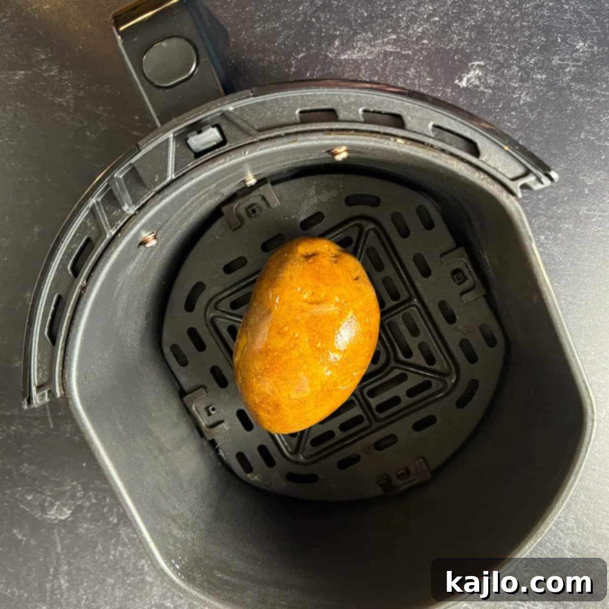 Russet potato baking in the air fryer basket