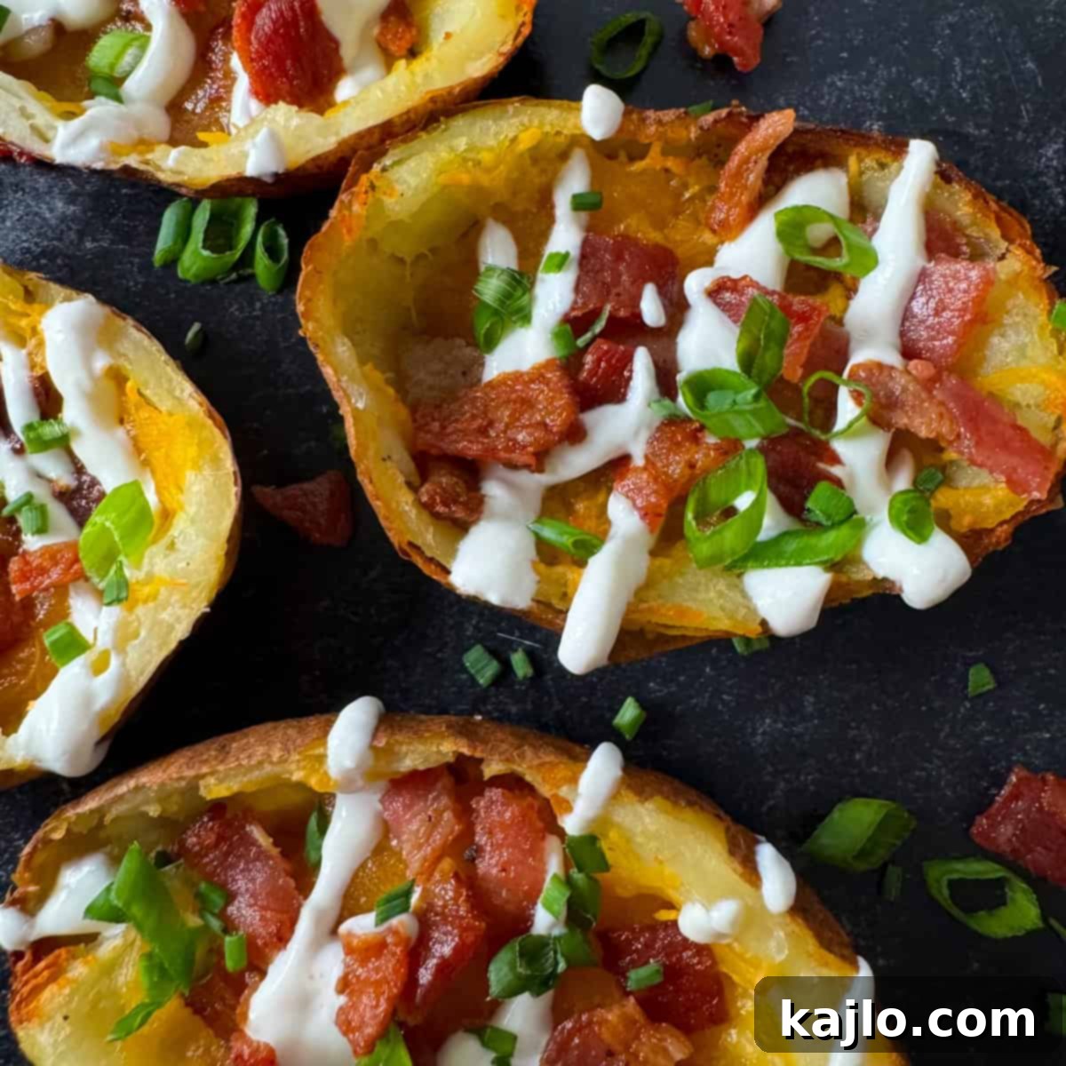Finished air fryer potato skins topped with sour cream and chives