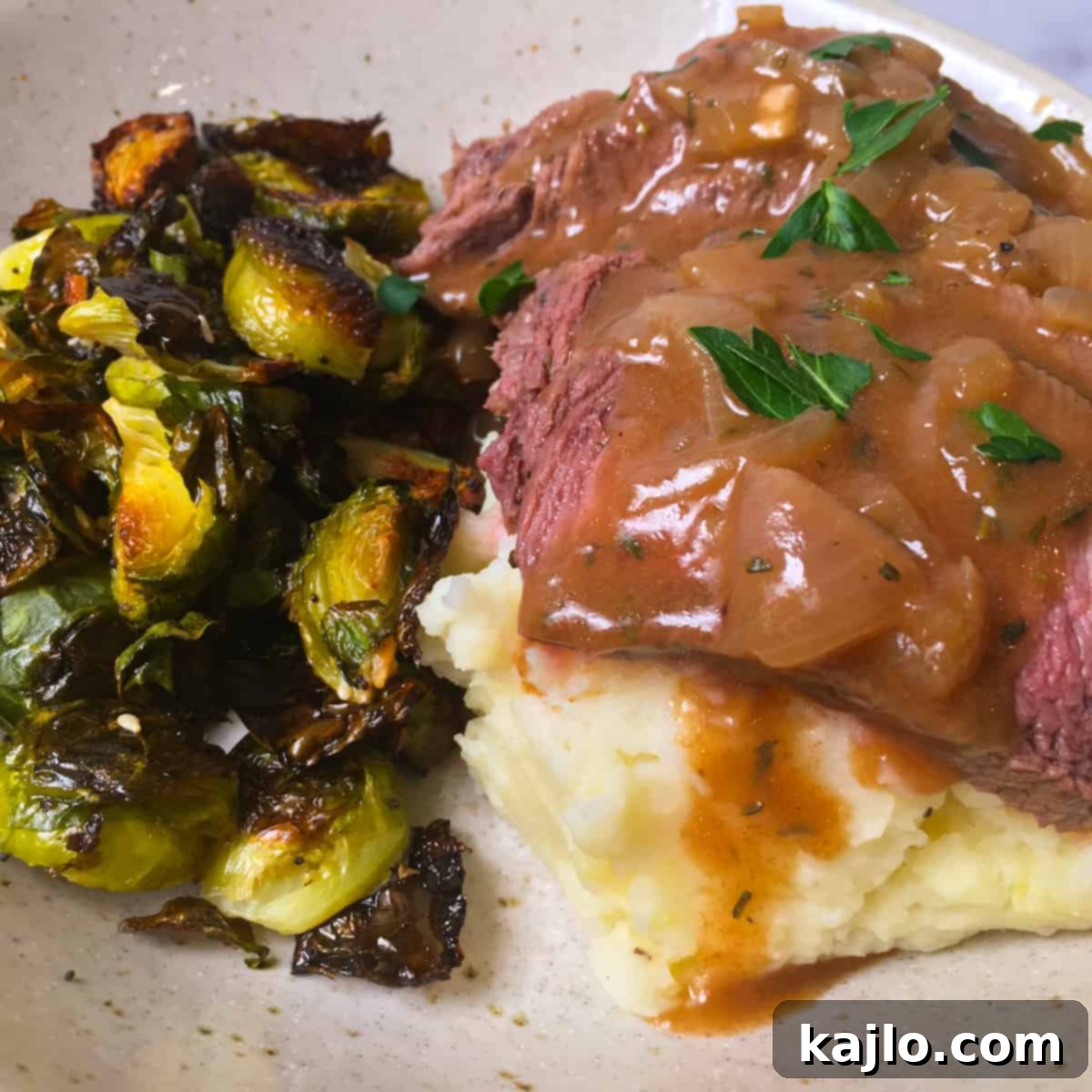 London Broil with gravy, mashed potatoes, and roasted Brussels sprouts