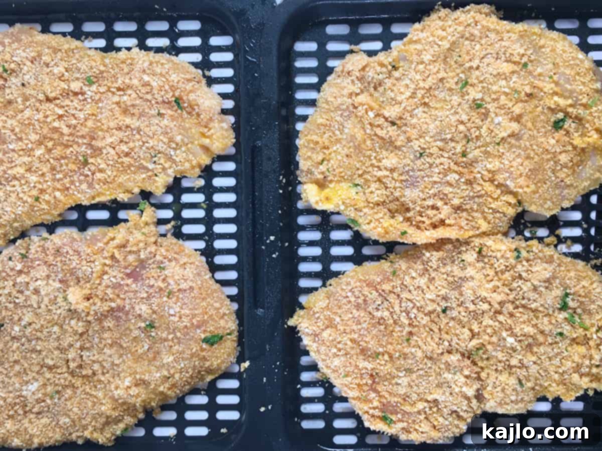 Quick Crispy Air Fryer Keto Chicken Schnitzel 3 chicken schnitzel on air fryer tray