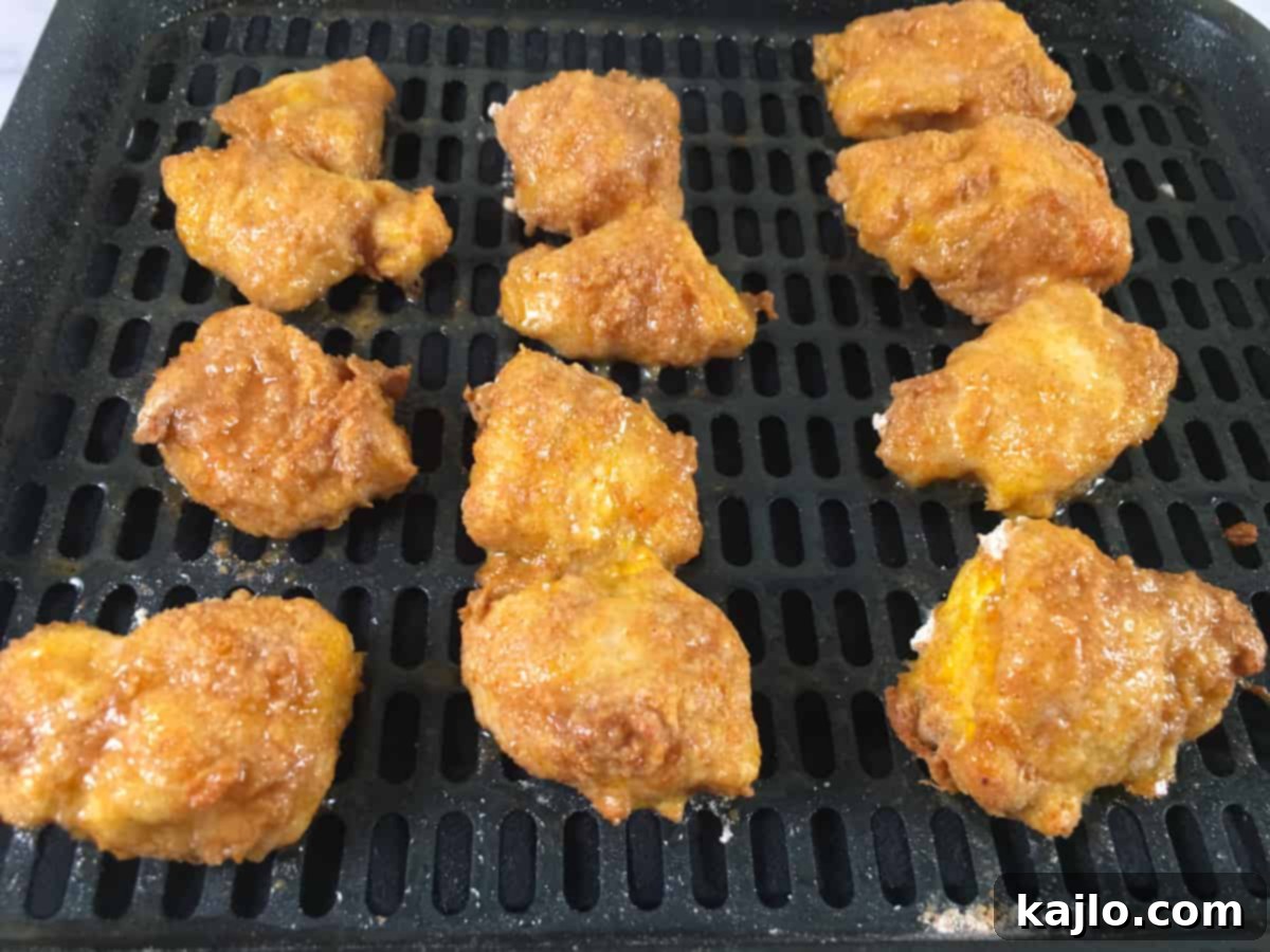 Air frying popcorn chicken in a single layer.