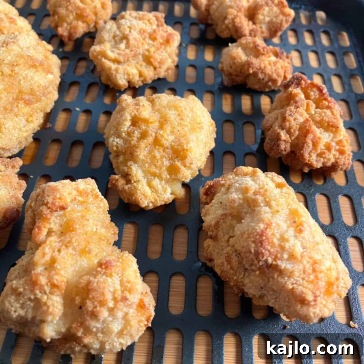 Frozen Tyson popcorn chicken cooking in an air fryer.