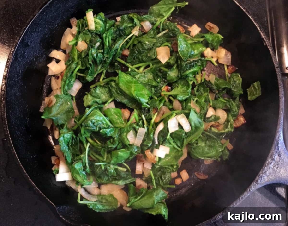 cooking baby kale and onions