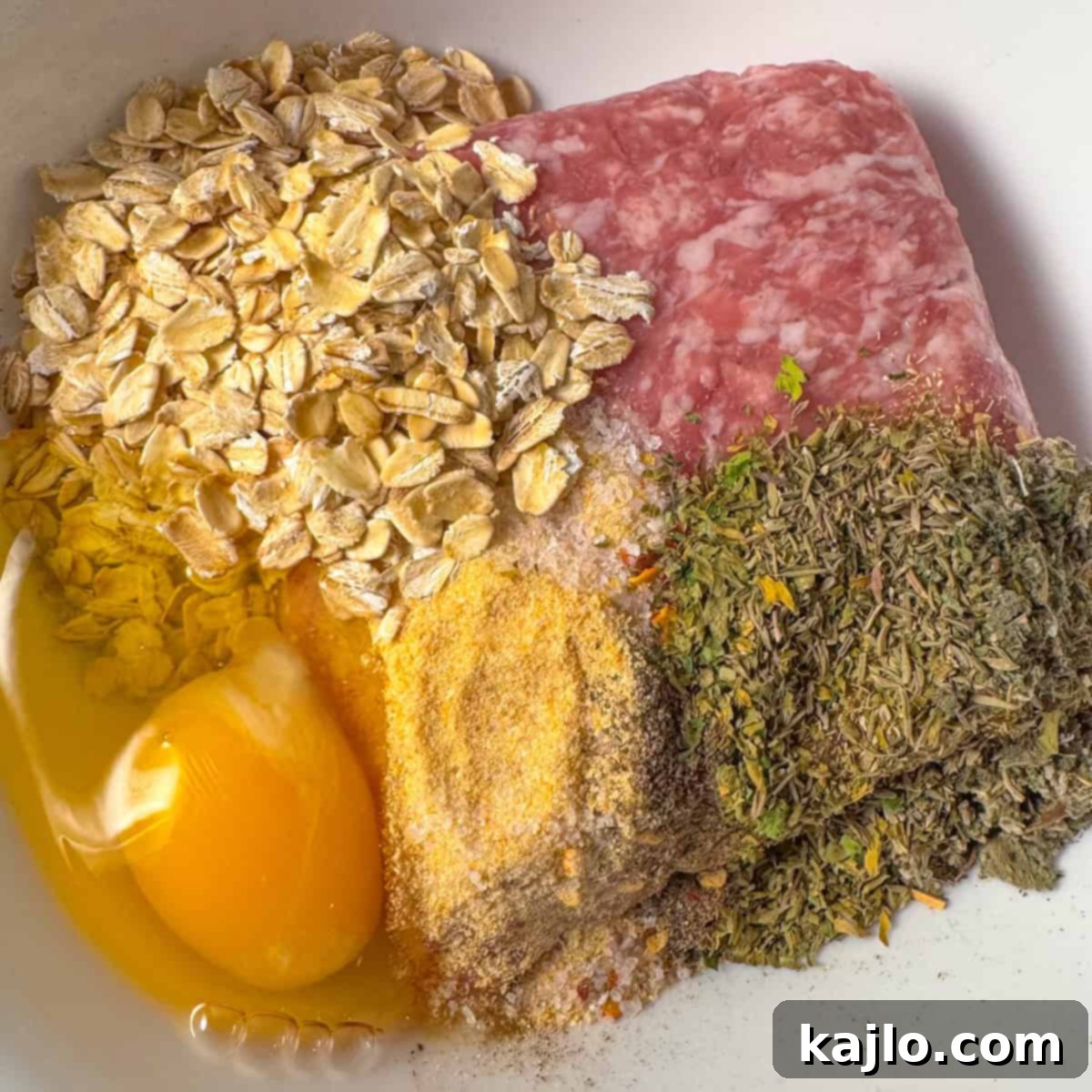 Hands mixing ground pork and spices to form homemade air fryer sausage patties