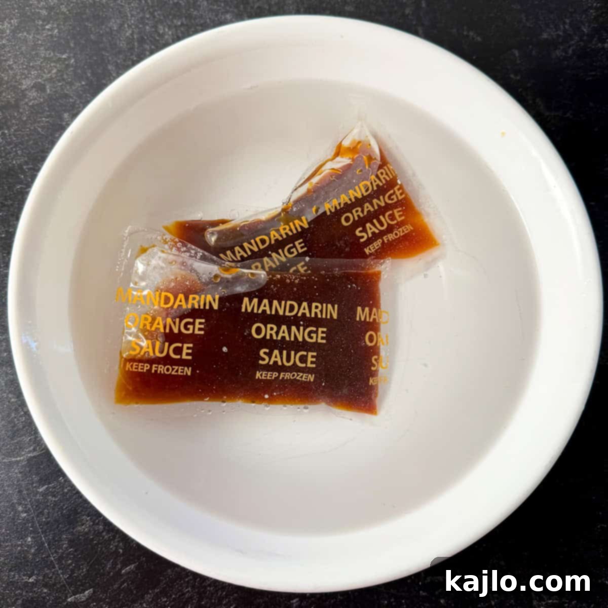 Thawing Orange Sauce Trader Joe's orange sauce packets thawing in warm water.