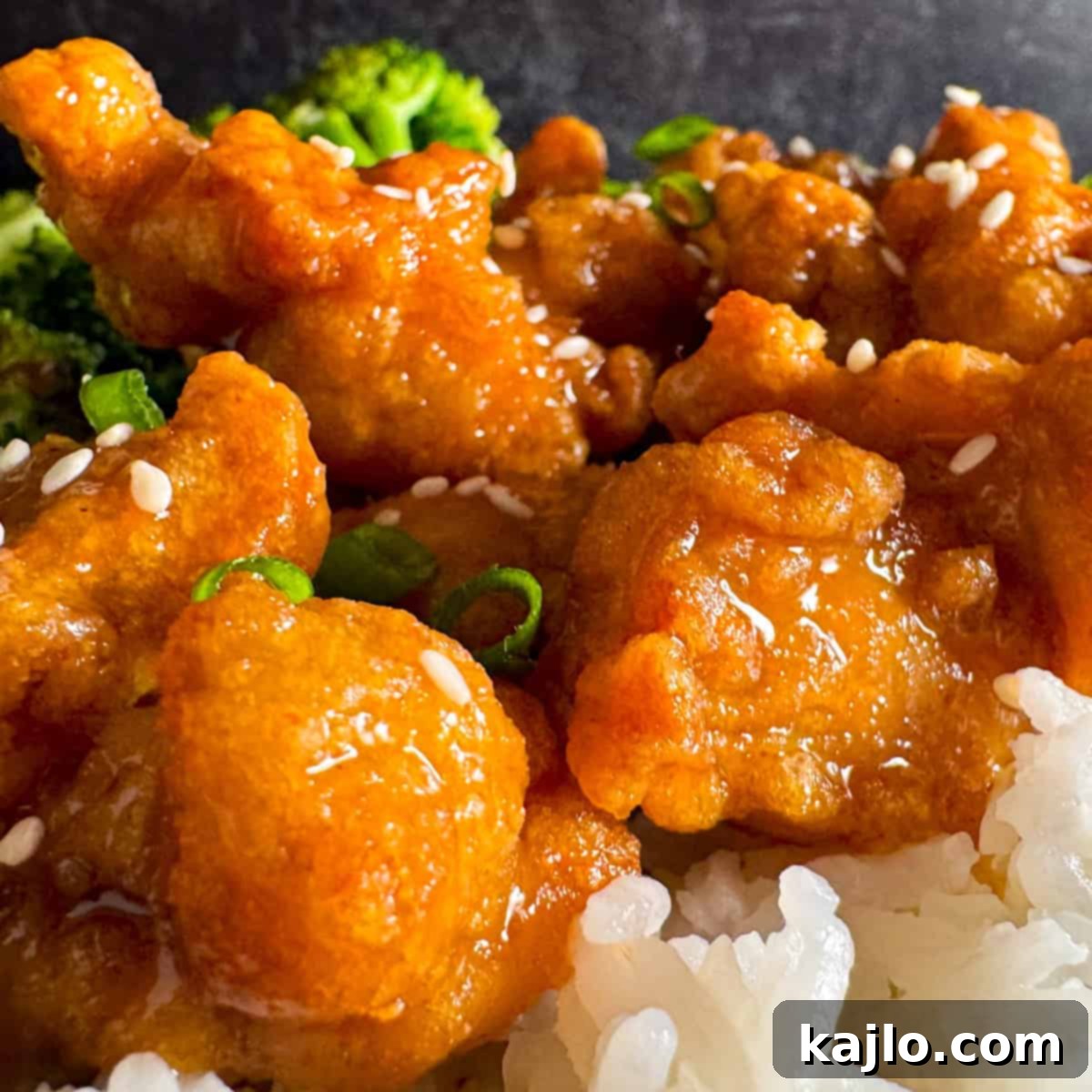 Sauced Orange Chicken Trader Ming's orange chicken tossed with sauce, ready to serve.