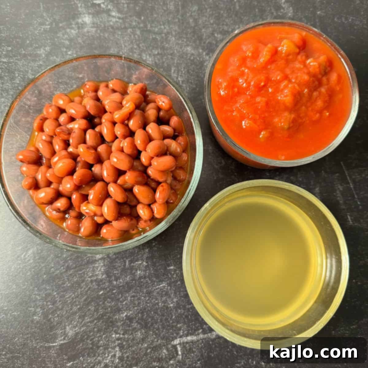 Easy Air Fryer Chili Bean Soup 3 All the simple ingredients for air fryer bean soup laid out: canned chili beans, salsa, vegetable broth, and cooking spray.