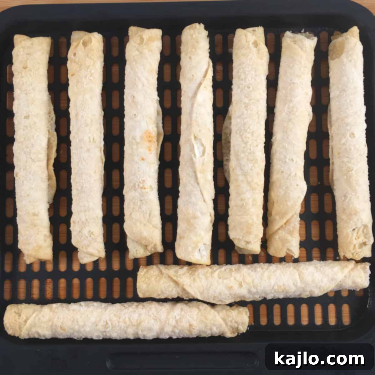 Air Fryer Frozen Flautas: Crispy Perfection in Minutes 5 Frozen taquitos laid out in a single layer in an air fryer basket