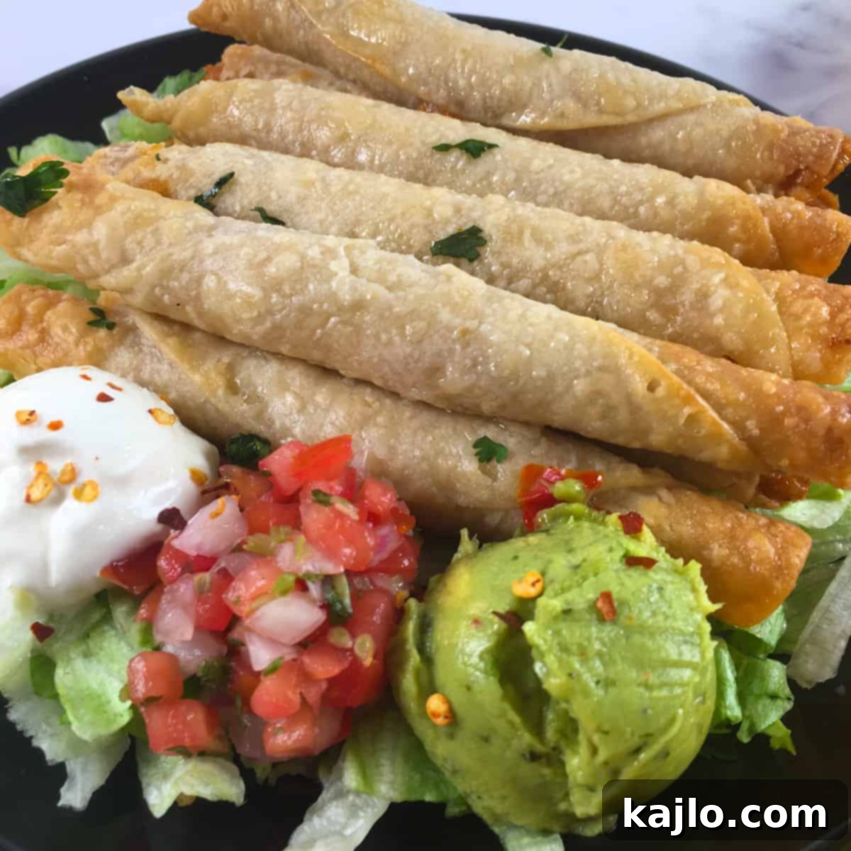 Air Fryer Frozen Flautas: Crispy Perfection in Minutes 6 Platter of taquitos with various dips and fresh vegetables