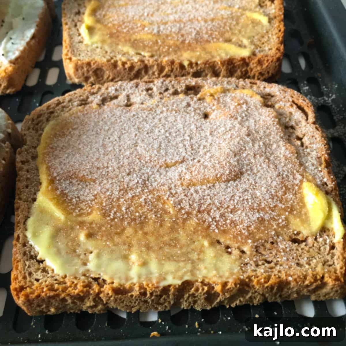 Cinnamon sugar sprinkled on air fryer toast, a sweet topping idea.