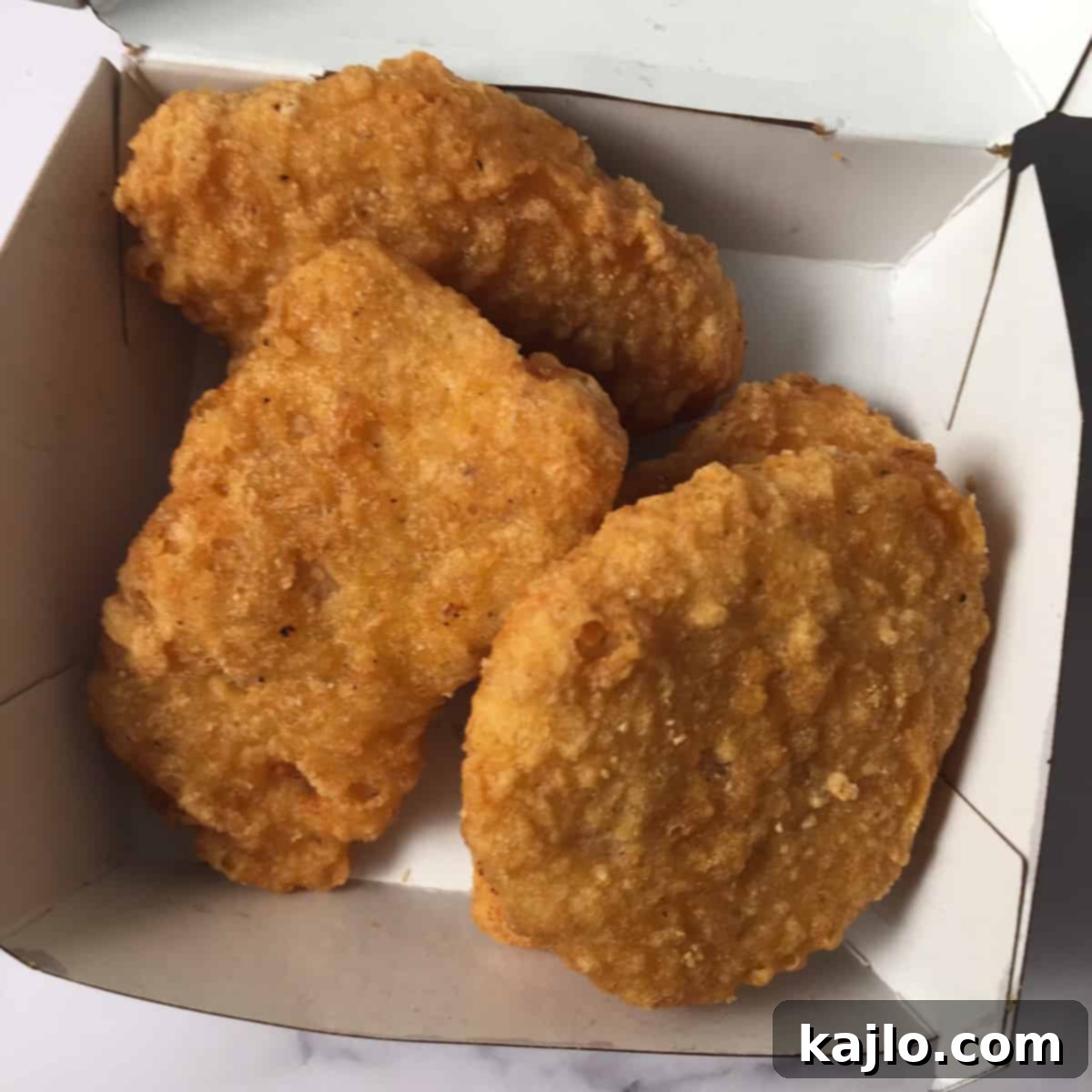 Get Crispy McDonald's Nuggets: Air Fryer Reheating Guide 4 chicken mcnuggets ready to be reheated