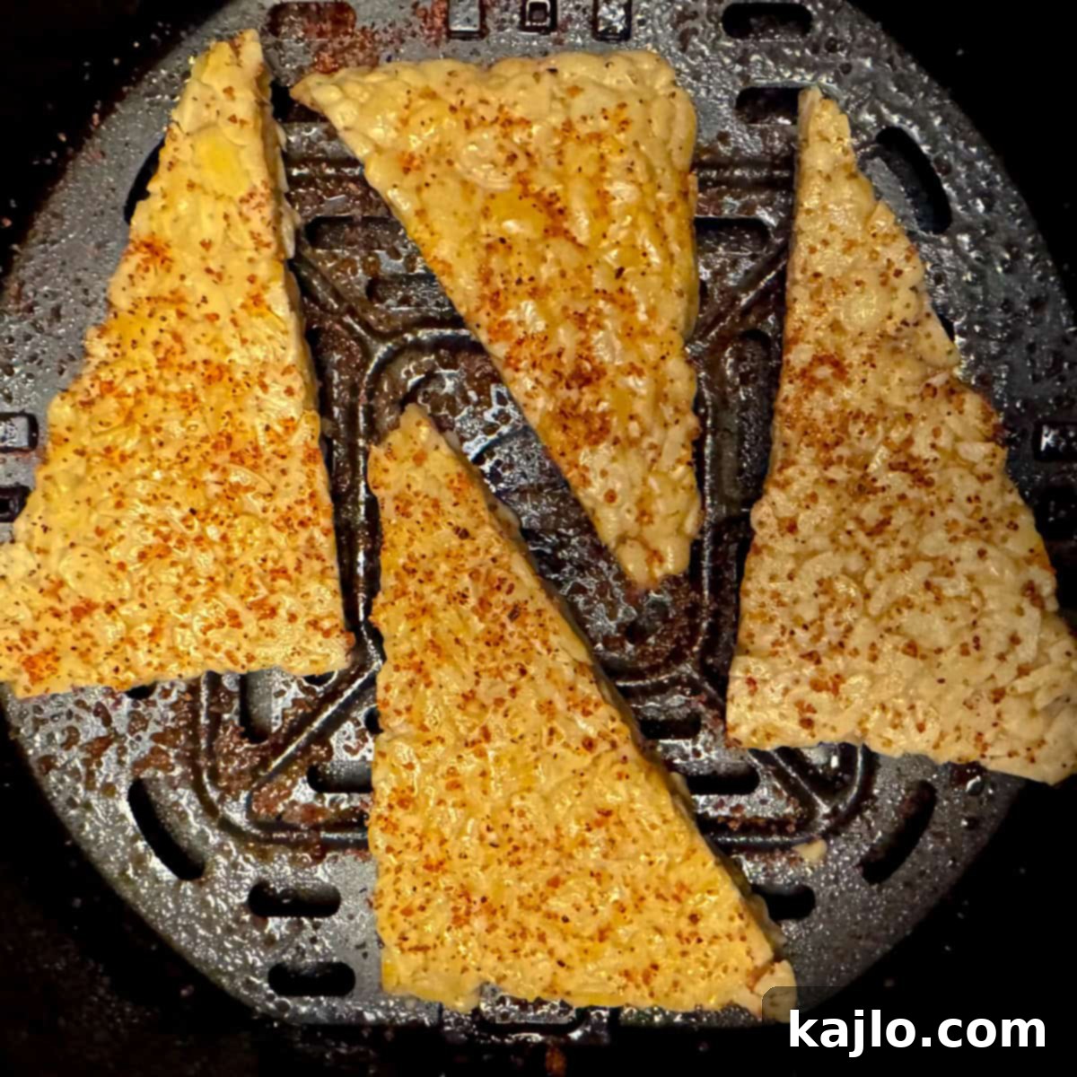 Seasoned tempeh placed in air fryer basket