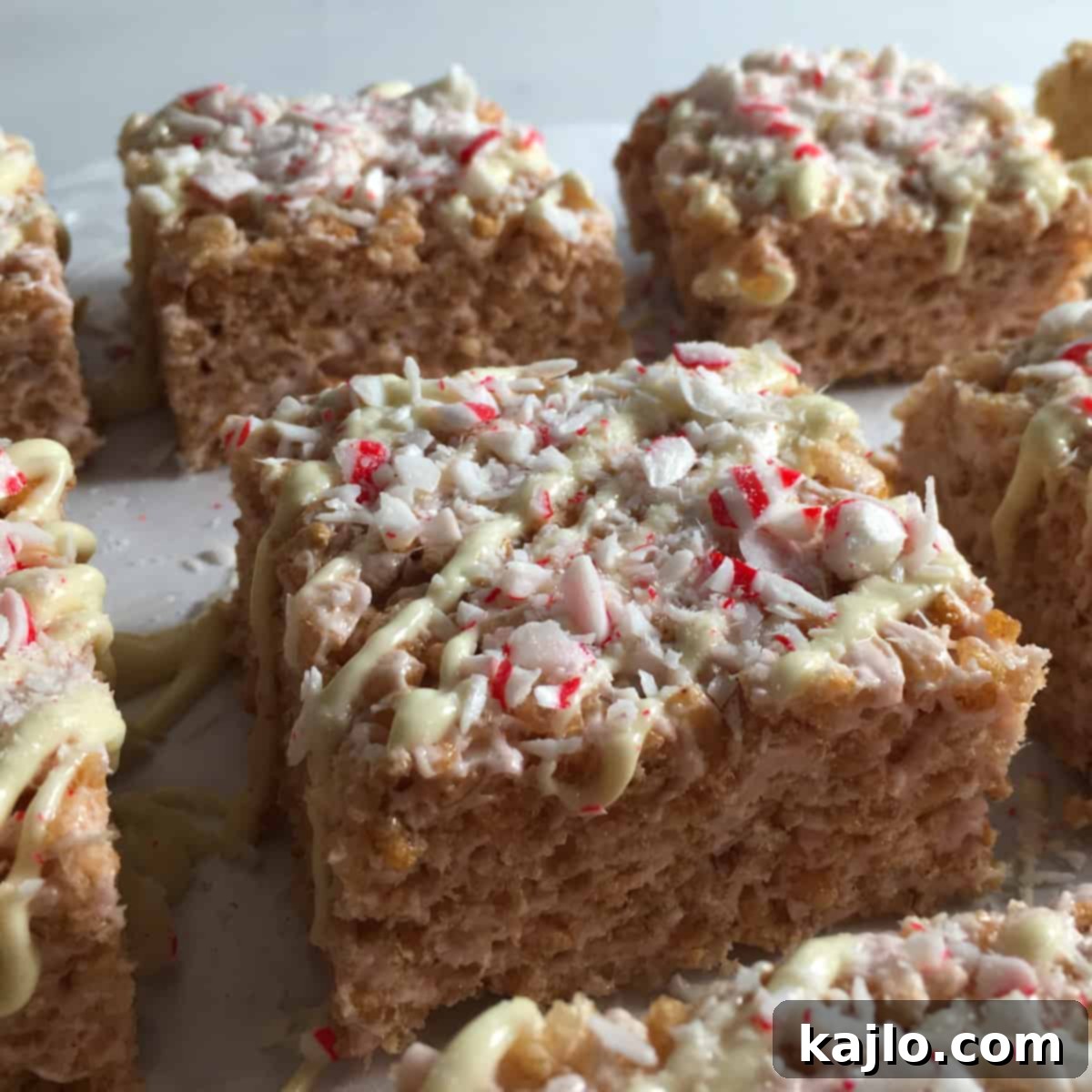 No-Bake Vegan Crispy Treats 9 Close-up of delightful mint rice crispy treats, featuring a chocolate drizzle and crushed peppermint candy.