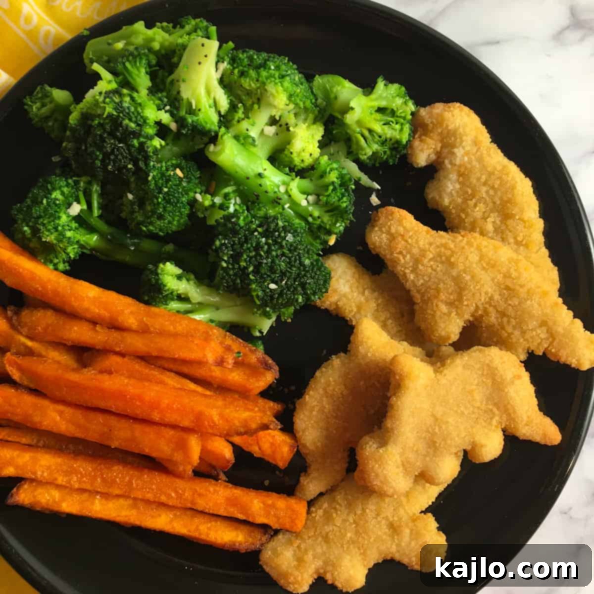 Crispy Dino Buddies Dinosaur Chicken Nuggets Air Fryer Recipe 5 Dino Buddies air fryer nuggets served with fries and ketchup