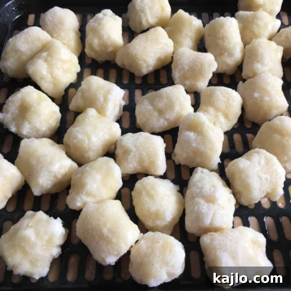 Crispy Air Fryer Trader Joe's Cauliflower Gnocchi 5 Frozen cauliflower gnocchi being placed in air fryer