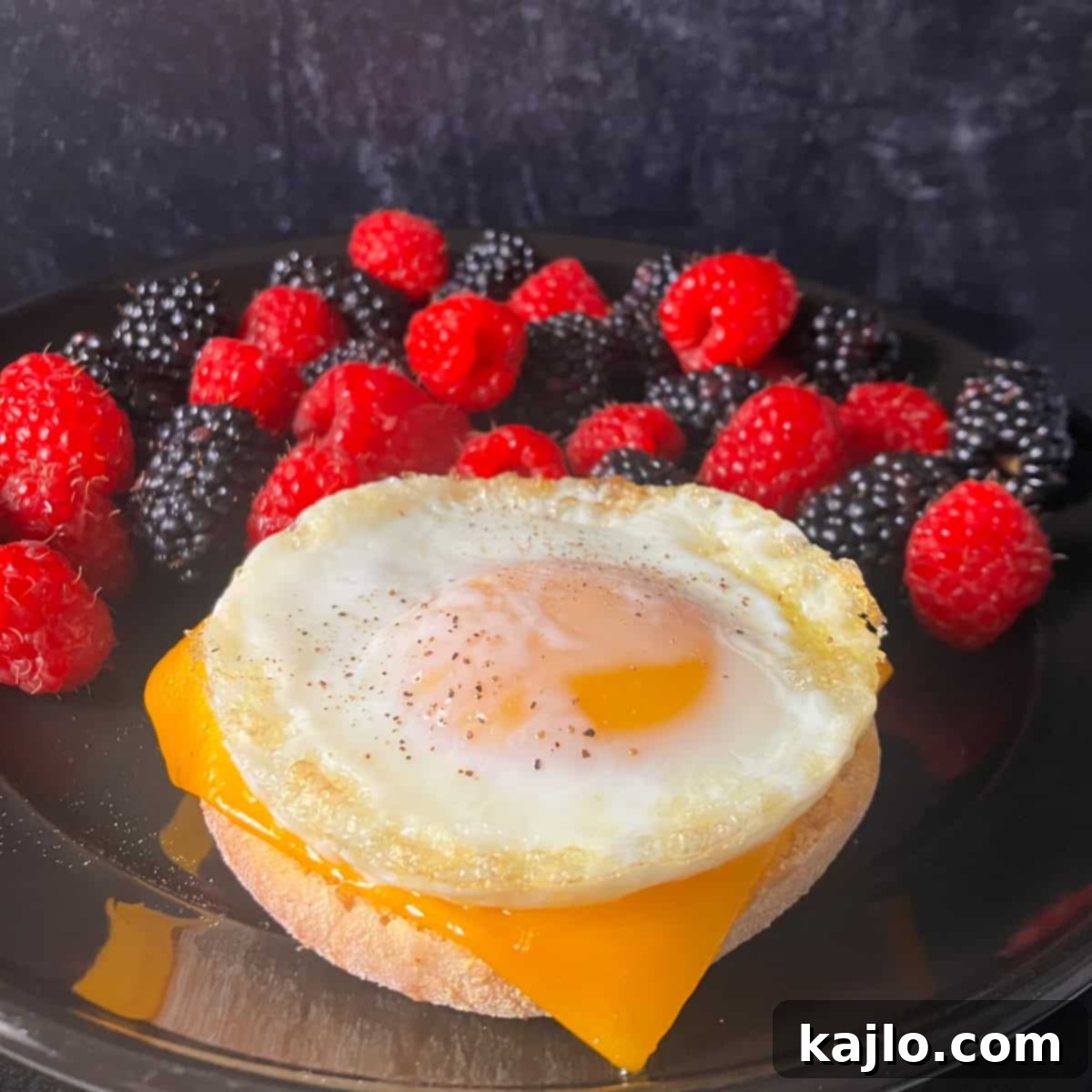 Delicious air fryer egg and cheese sandwich on an English muffin, ready to eat.