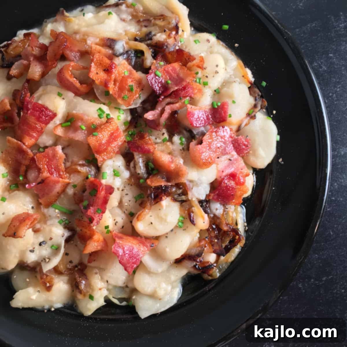 Easy Instant Pot Lima Beans 4 A bowl of Instant Pot lima beans garnished with bacon and chives