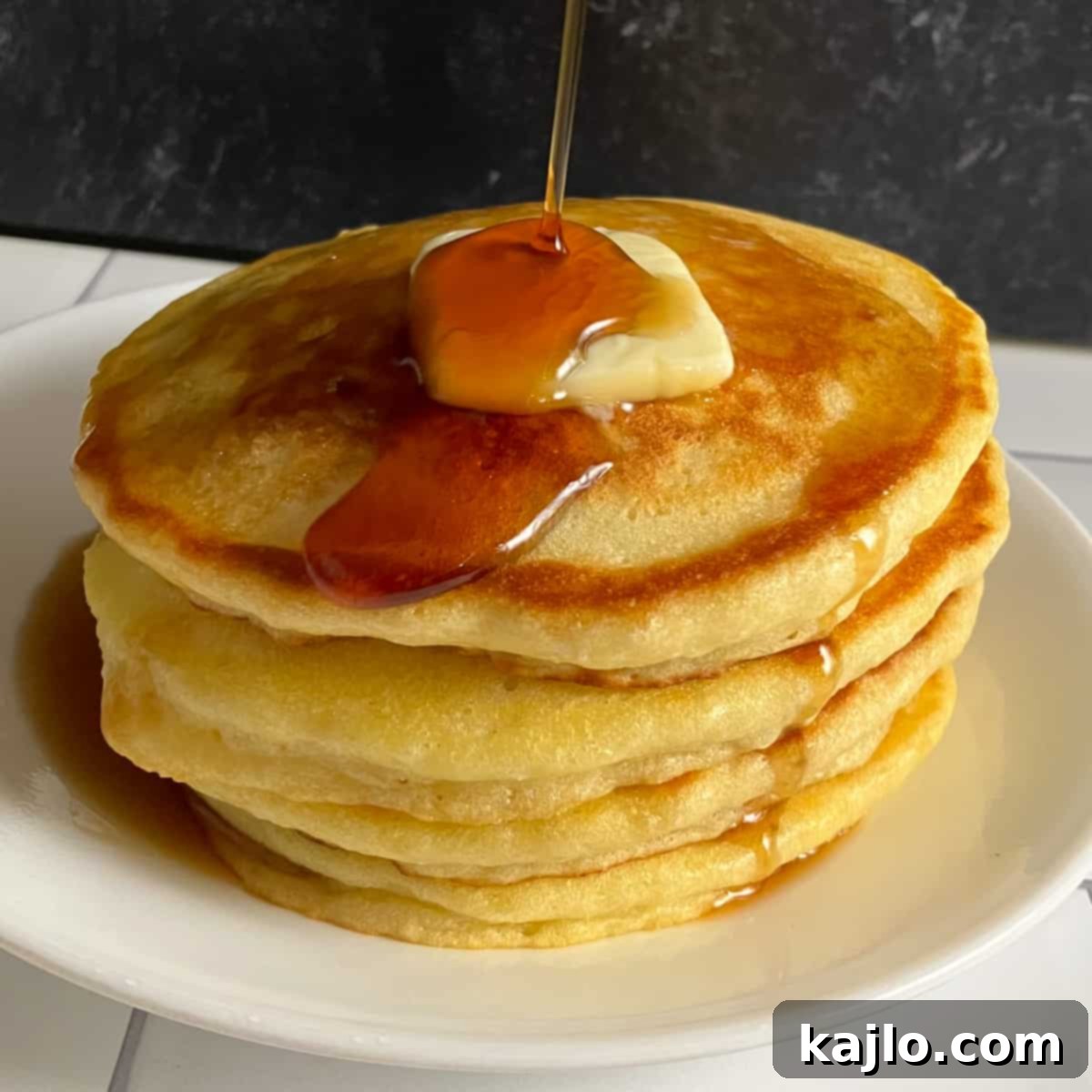 Delicious and fluffy Denny's pancakes served with syrup.