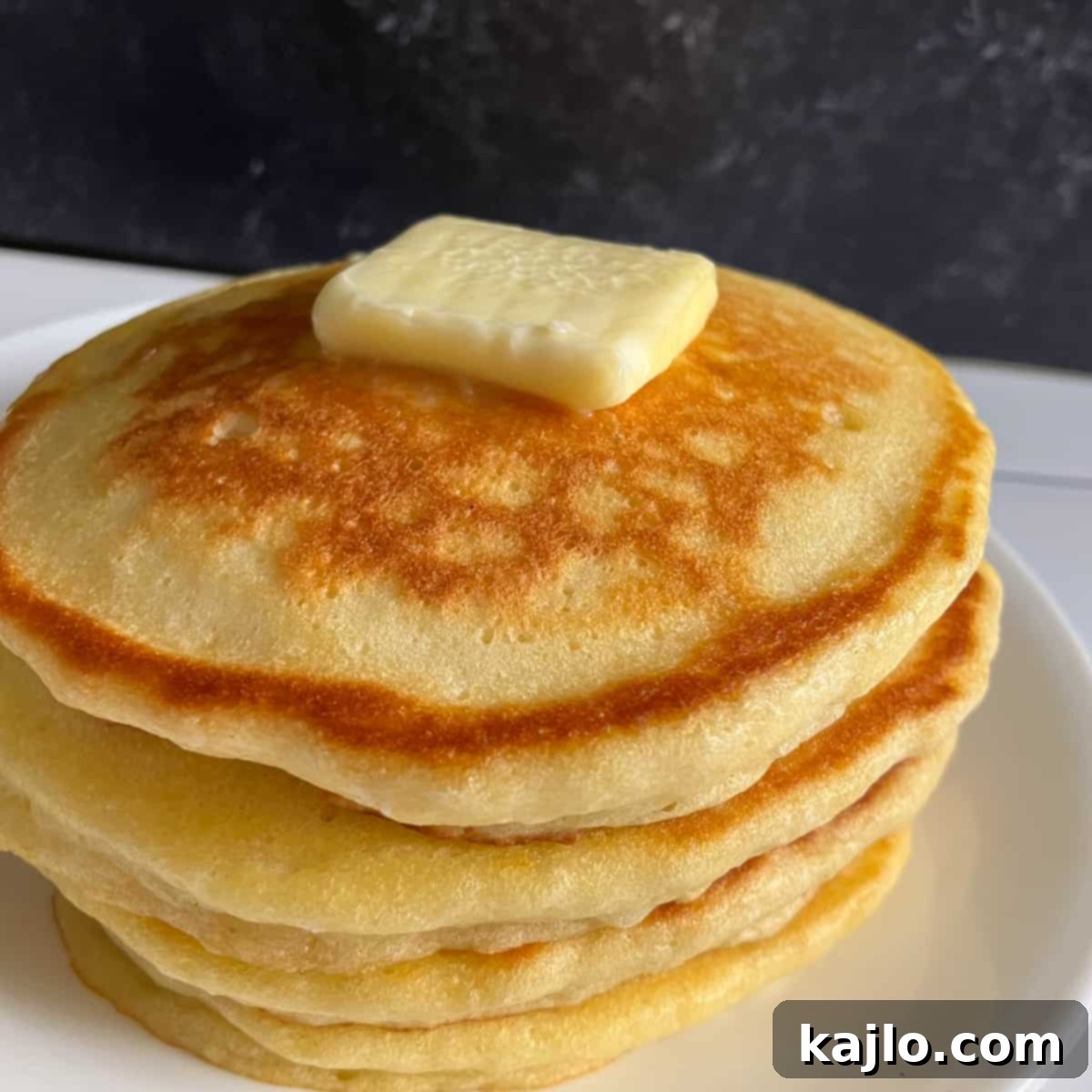 Stack of freshly made Denny's pancakes ready to be served.