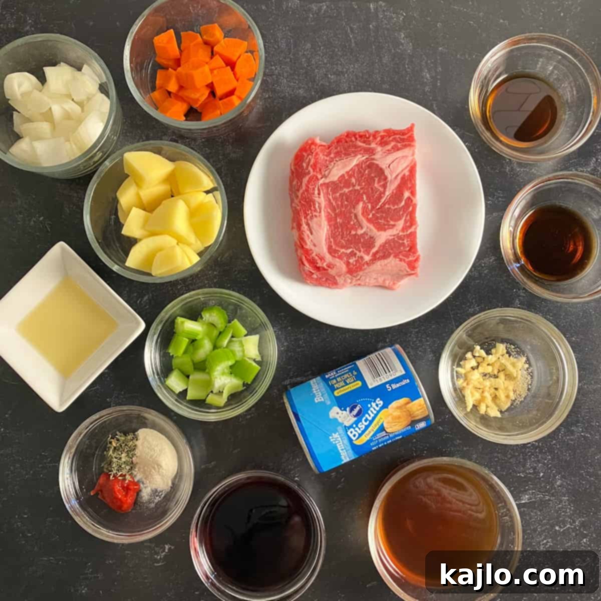 All ingredients for air fryer beef stew laid out on a white surface.