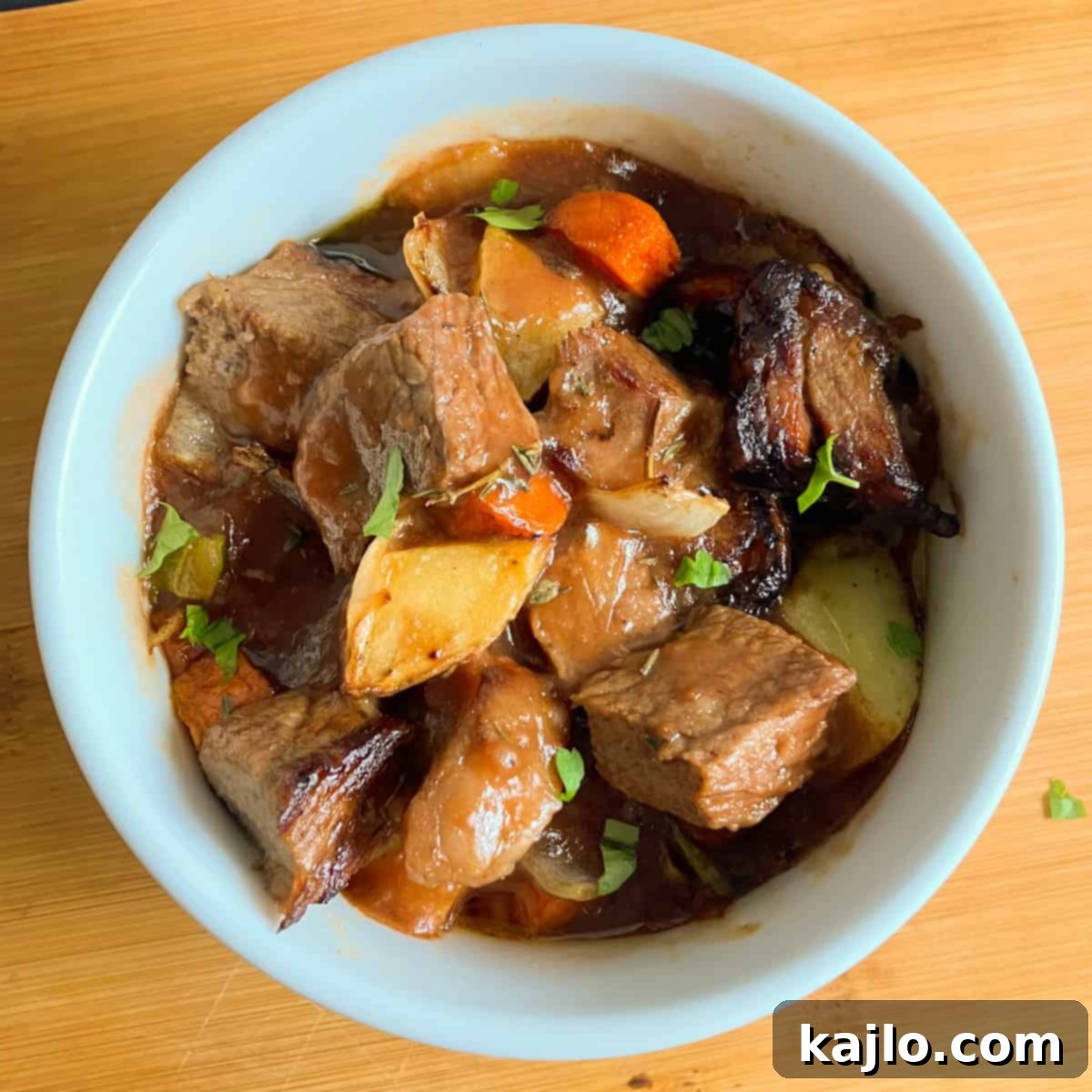 A close-up shot of a serving of beef stew cooked in an air fryer, highlighting its rich texture.