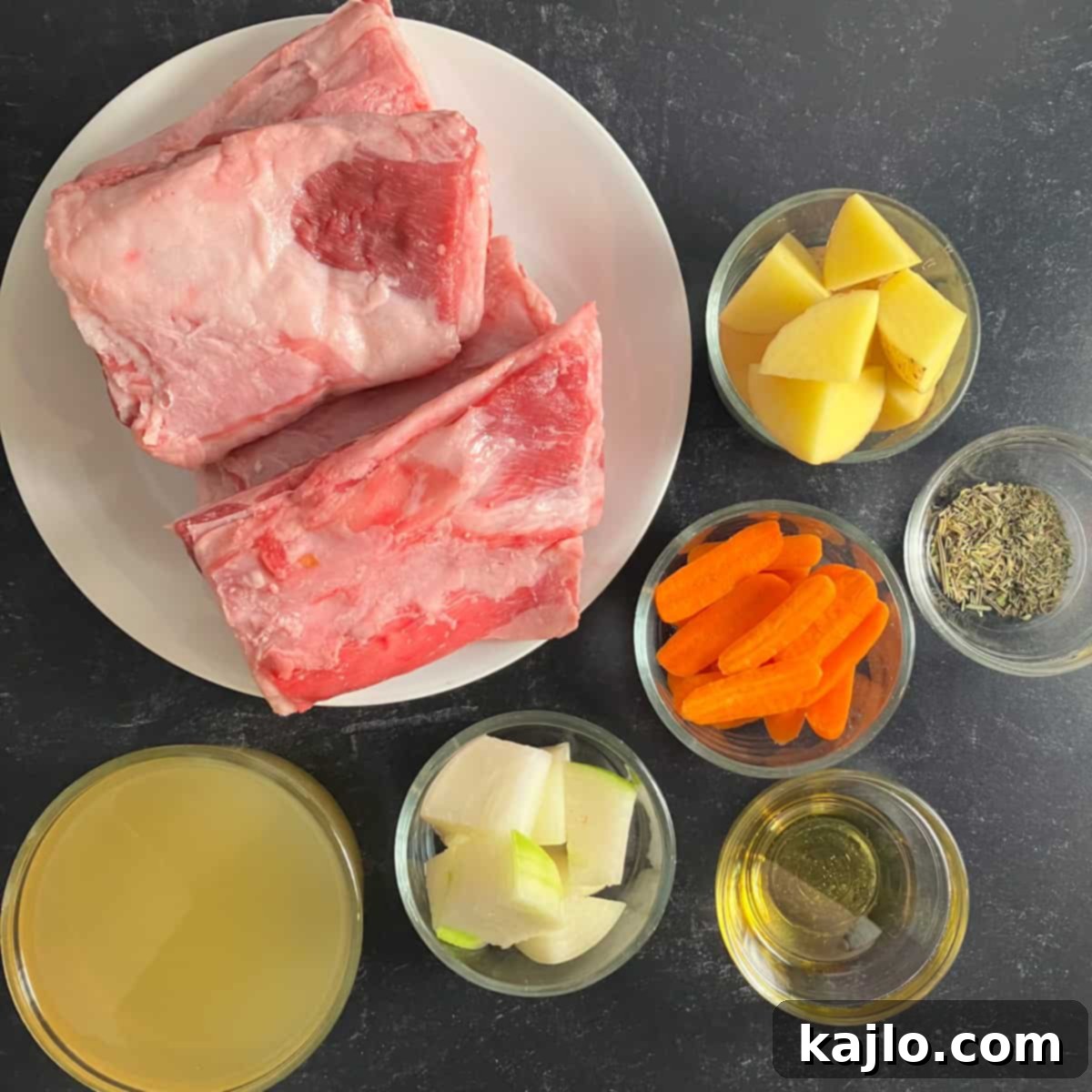 Ingredients for lamb breast recipe laid out on a wooden surface