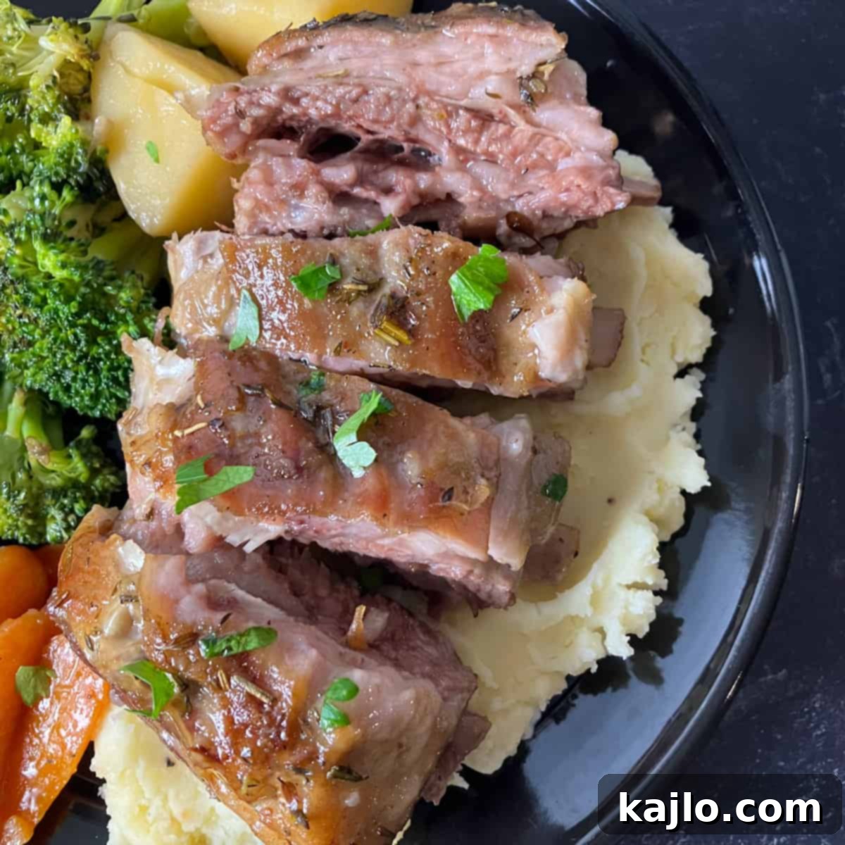 Sliced lamb breast on a cutting board after resting