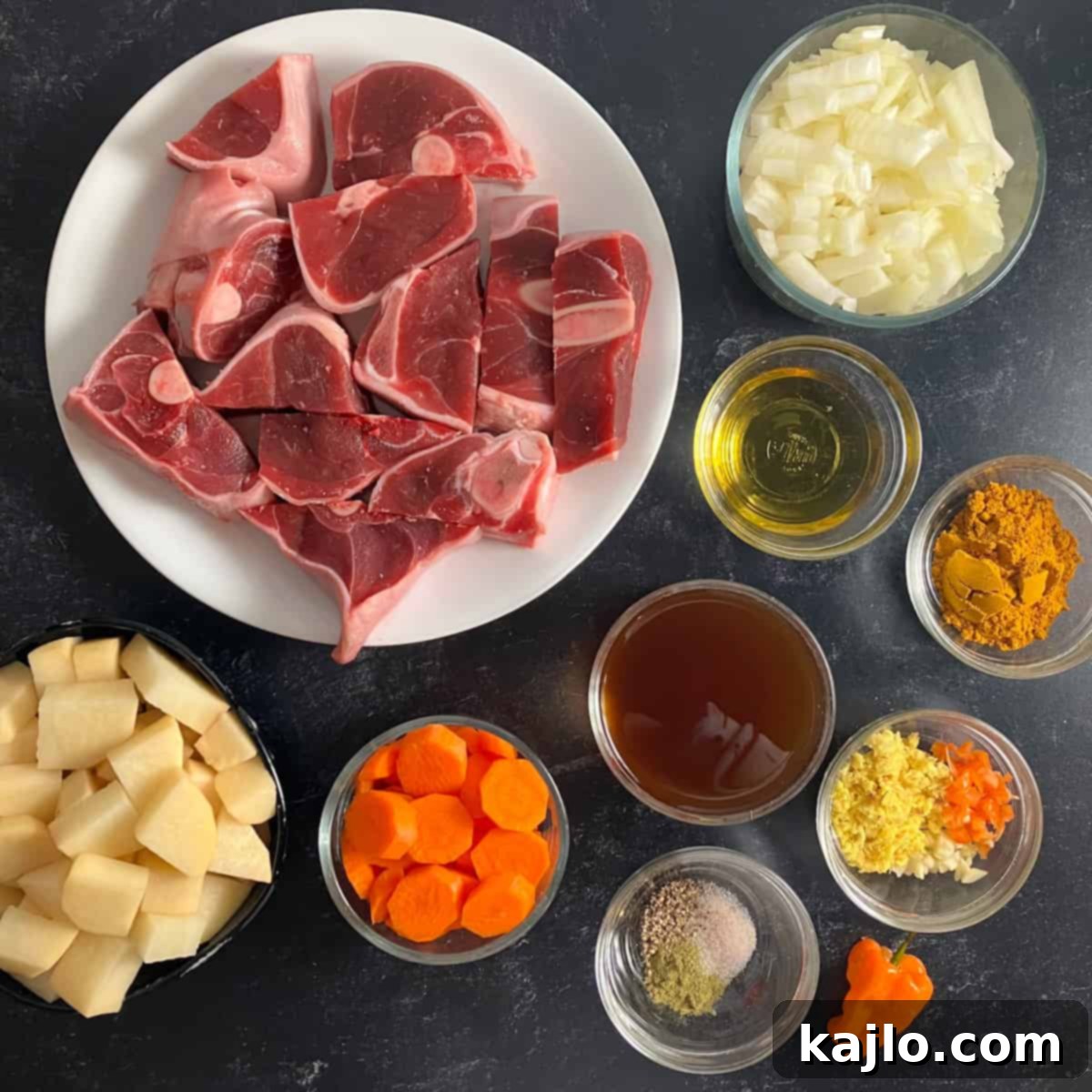 Goat Meat Your Complete Guide to Recipes Sourcing and Health Benefits 4 A flat lay image displaying all the fresh ingredients needed for a goat meat curry, including goat meat, vegetables, and spices.
