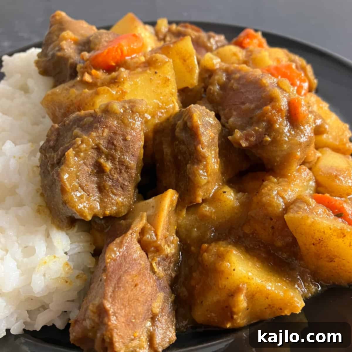 Goat Meat Your Complete Guide to Recipes Sourcing and Health Benefits 8 A close-up of a rustic goat curry dish, showing rich color and tender meat, ready to be enjoyed.