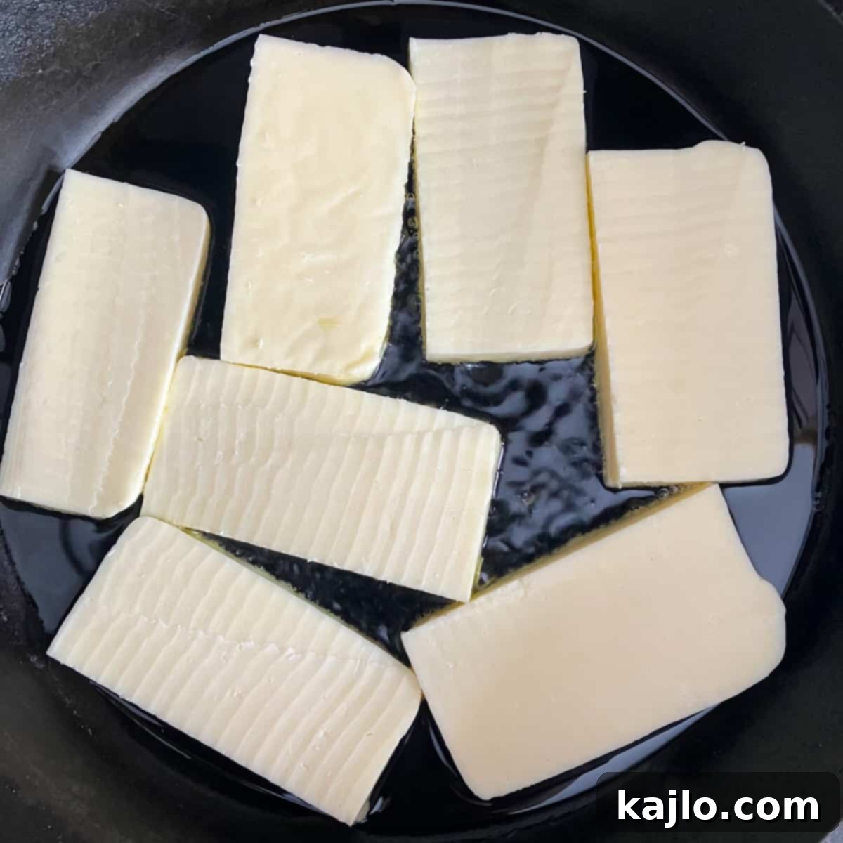 Crispy Mexican Fried Queso Fresco 4 Sliced frying cheese ready for cooking.