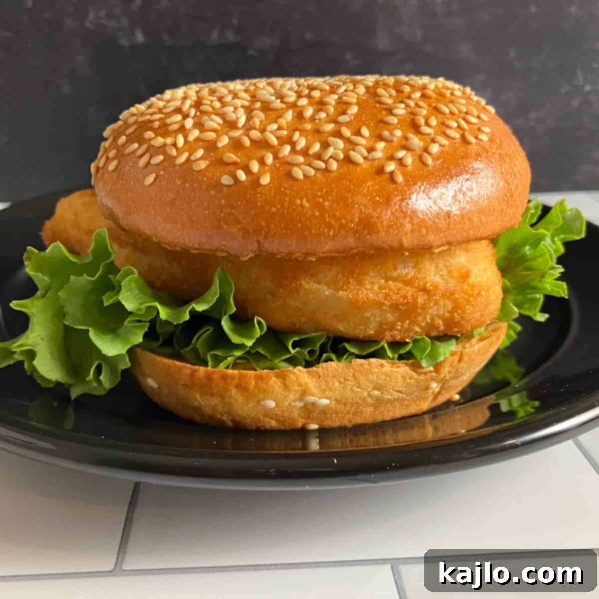 Hardee's Fish Sandwich Recipe - Golden brown crispy fish fillet on a sesame bun with lettuce and tartar sauce