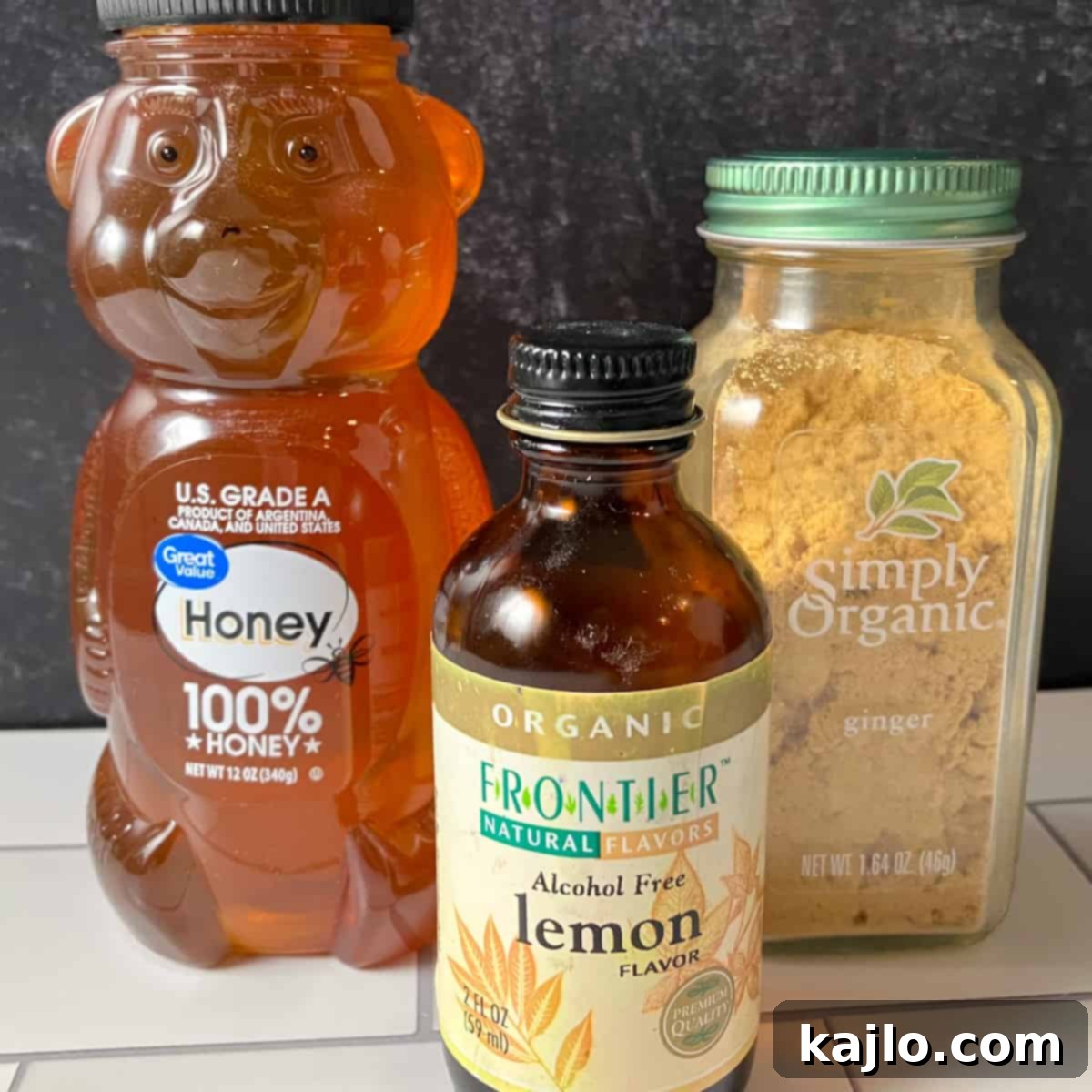 Soothing Honey Lollipops for Coughs and Tea 3 Ingredients for honey lollipops including honey, lemon extract, and ginger powder.