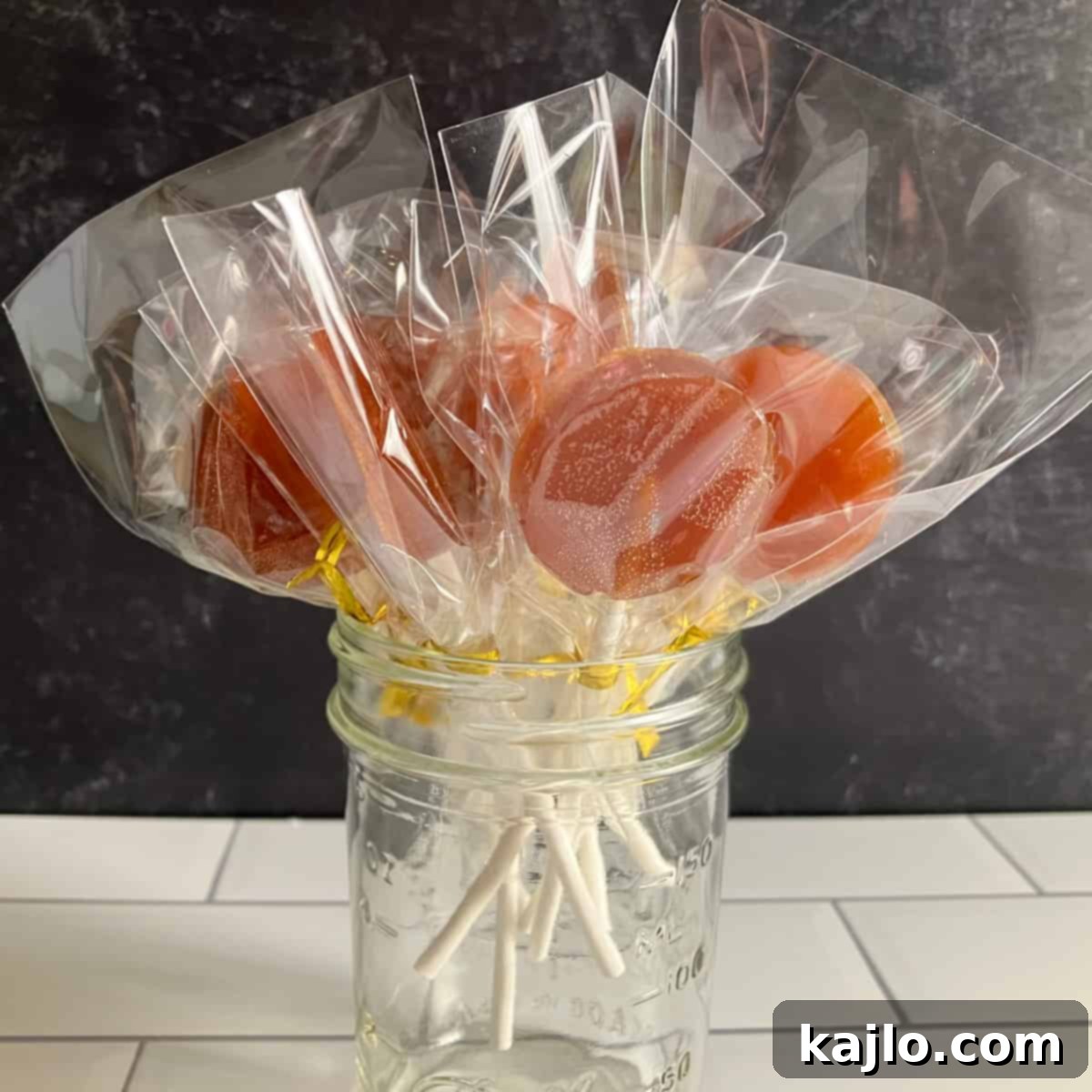 Soothing Honey Lollipops for Coughs and Tea 5 Equipment for making honey lollipops, including molds, sticks, and a candy thermometer.
