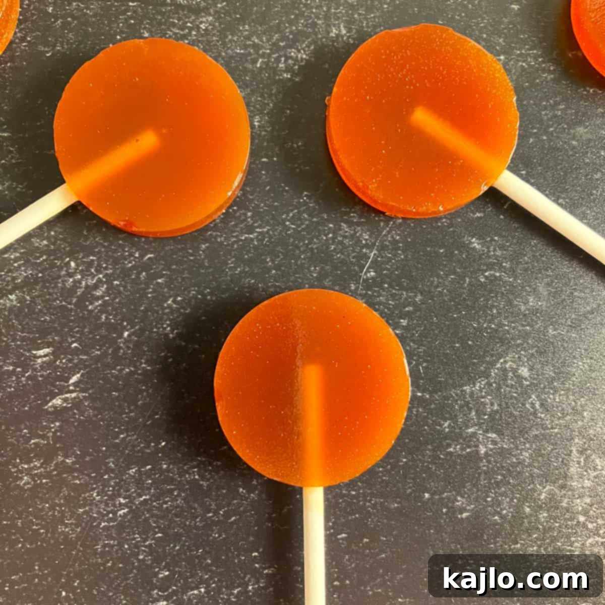 Soothing Honey Lollipops for Coughs and Tea 9 Close-up of golden honey suckers on a tray, ready to be enjoyed.