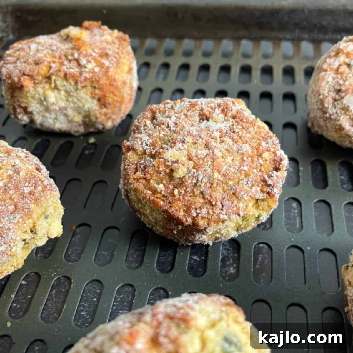 Trader Joe's Frozen Falafel Air Fryer Recipe 3 Frozen falafel pieces laid out in a single layer in an air fryer basket.