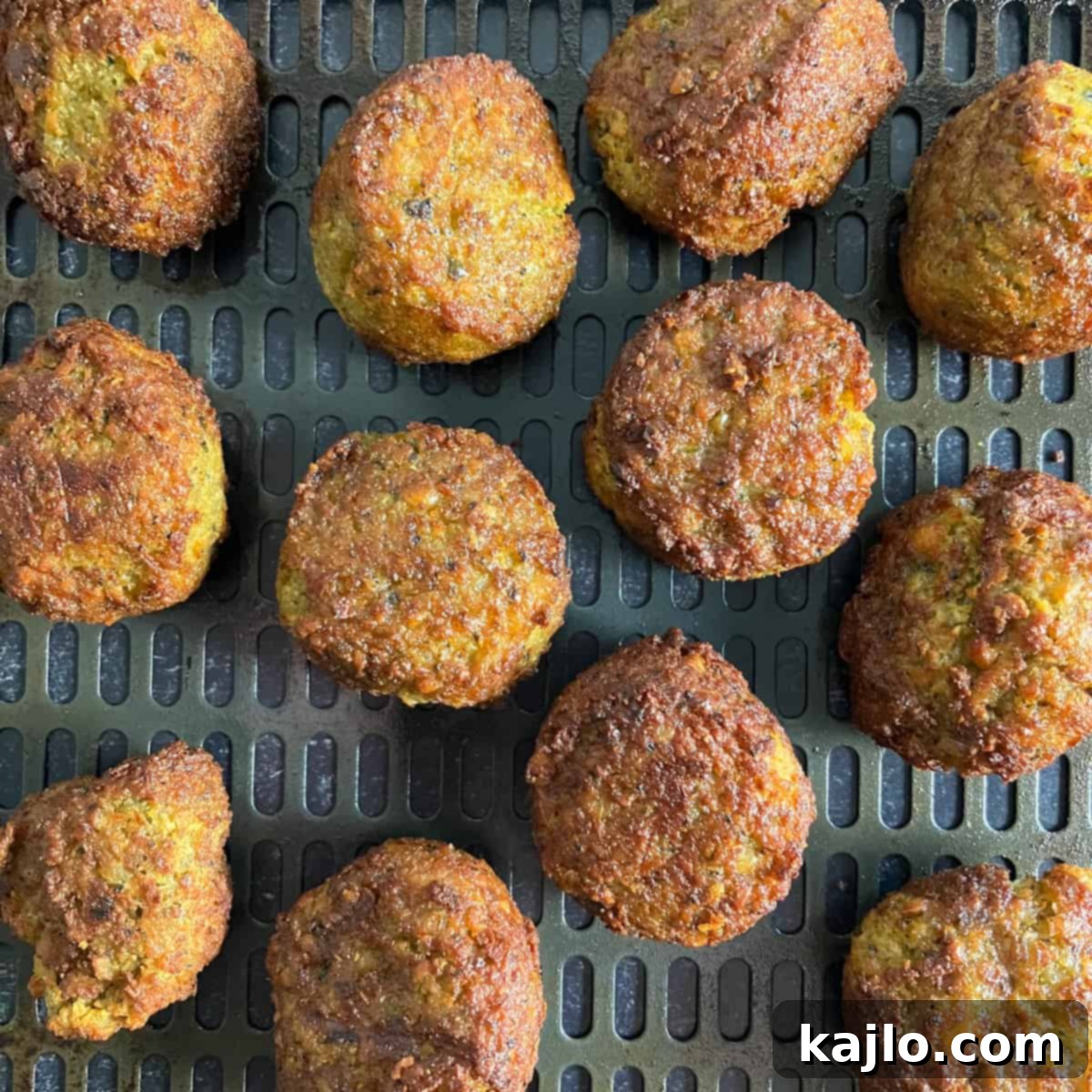 Trader Joe's Frozen Falafel Air Fryer Recipe 6 Air fryer basket filled with crispy golden falafel, ready to serve.