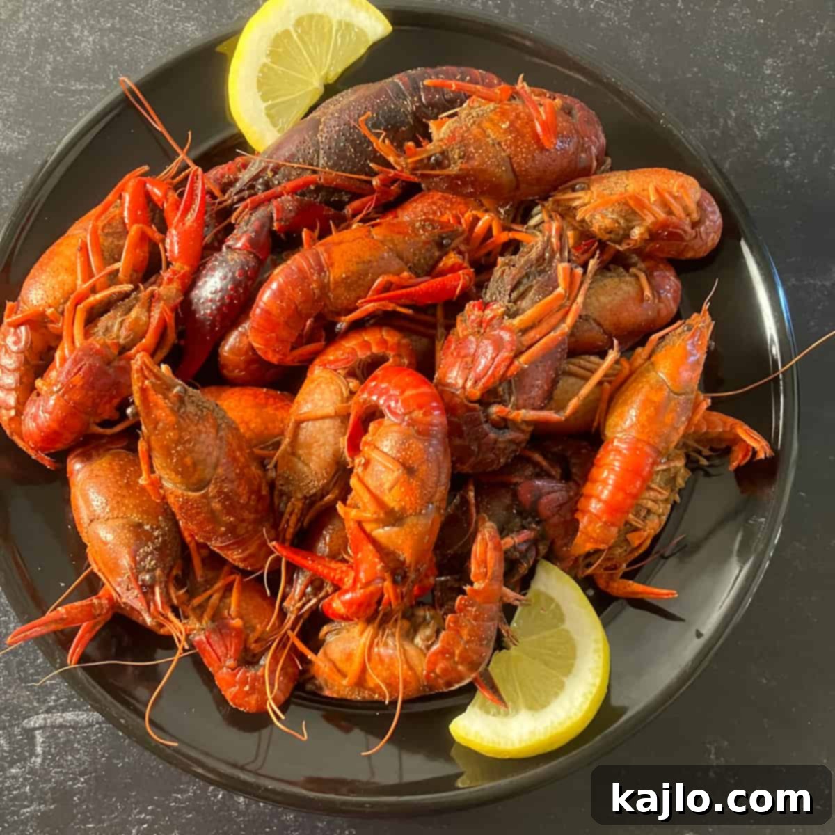 Perfectly cooked air fryer crawfish in a basket, garnished with lemon