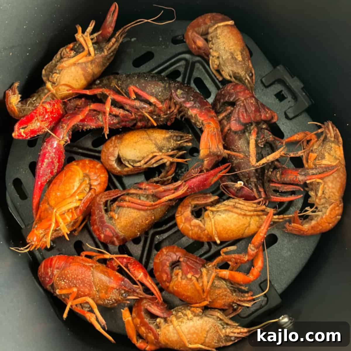 Crawfish actively cooking and crisping up in an air fryer