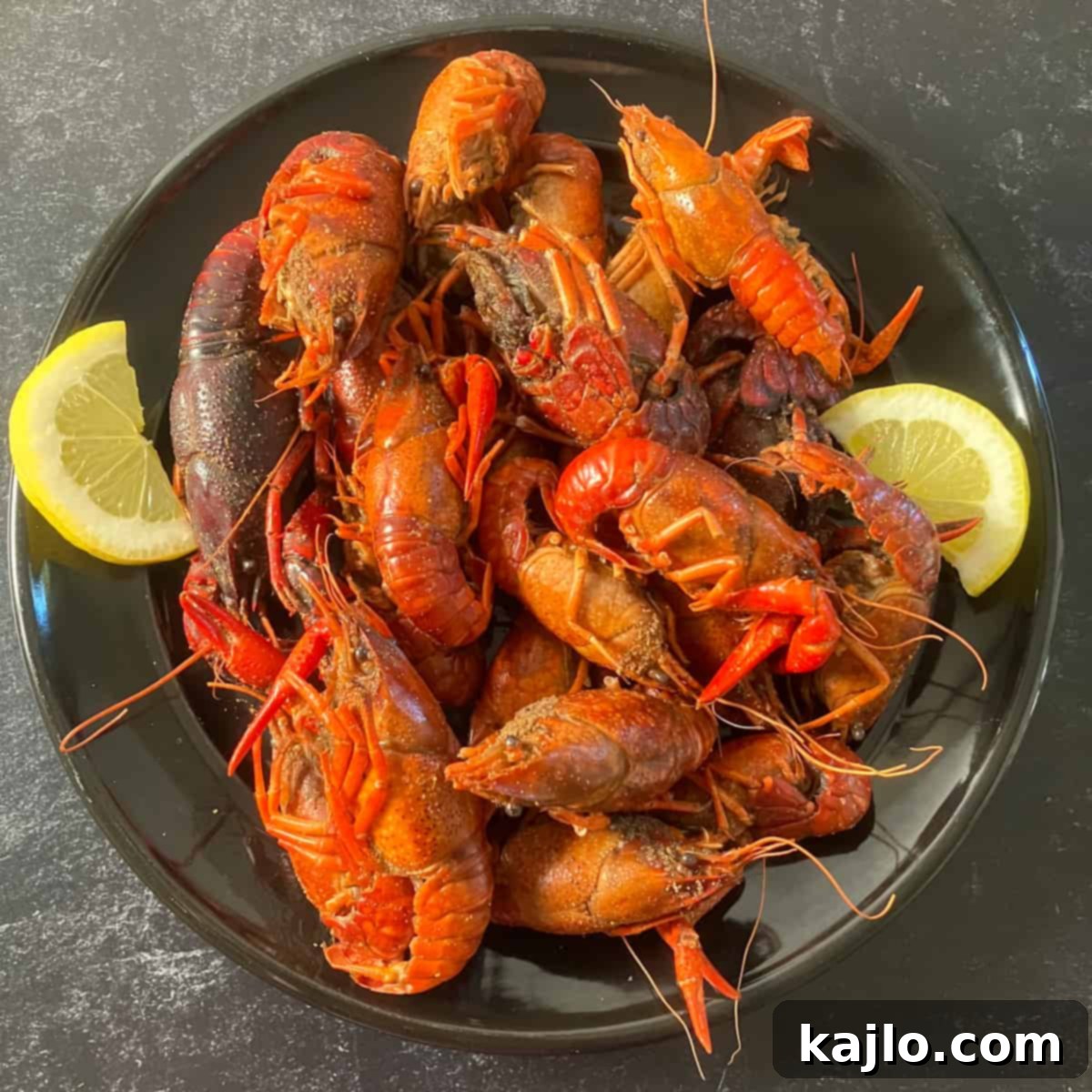 Cooked air fryer crawfish served with lemon and butter, ready to be eaten