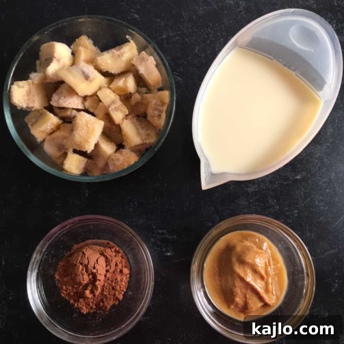 Sugar-Free Vegan Banana Popsicles 4 A selection of the simple ingredients needed for sugar free banana pops, including frozen bananas and peanut butter.