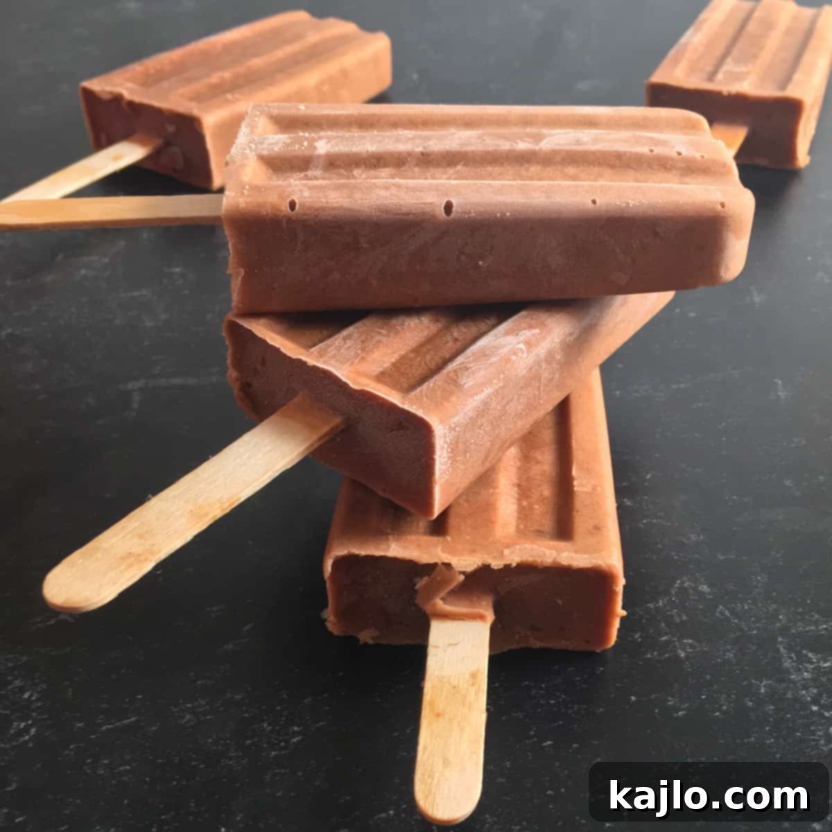 Sugar-Free Vegan Banana Popsicles 7 A variety of sugar free banana pops, showcasing different flavors and toppings.