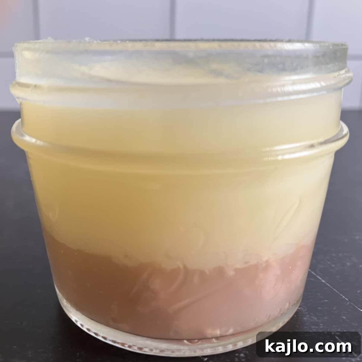 Homemade Crock Pot Tallow 10 tallow and collagen - clarified tallow in a jar with solidified collagen on top