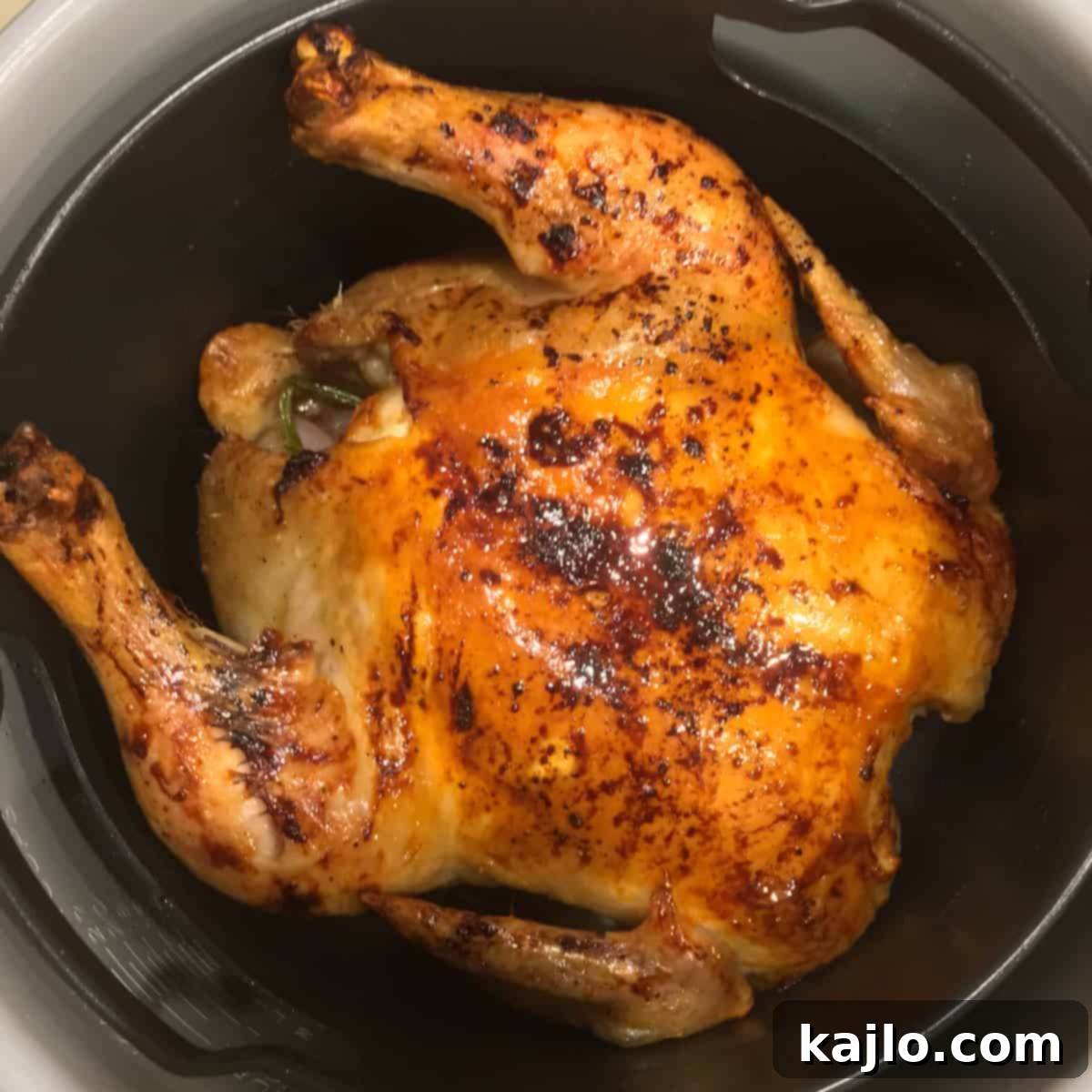 Delicious Ninja Foodi whole chicken, ready to be carved and served.
