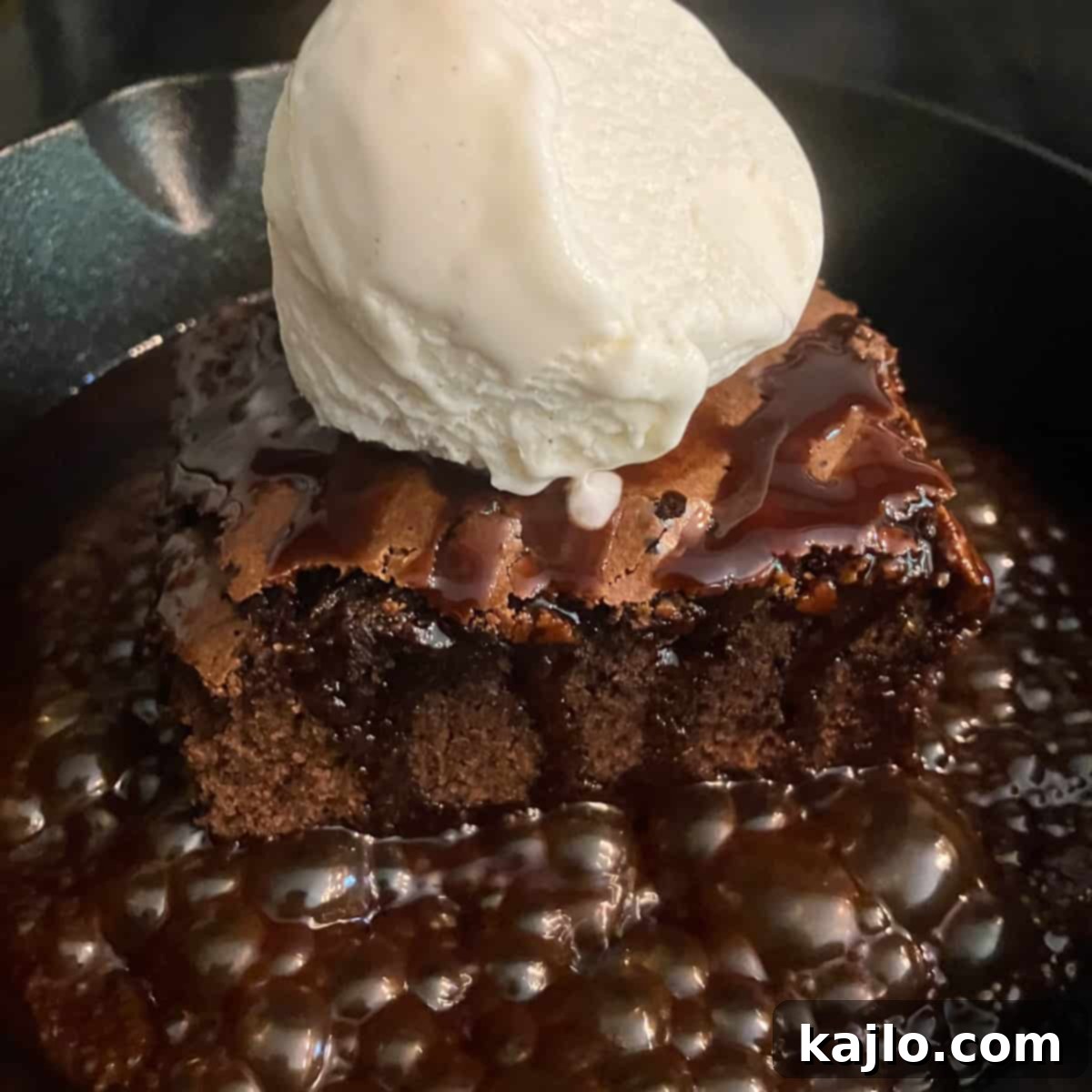 sizzling brownie served on a cast iron skillet with ice cream and chocolate sauce
