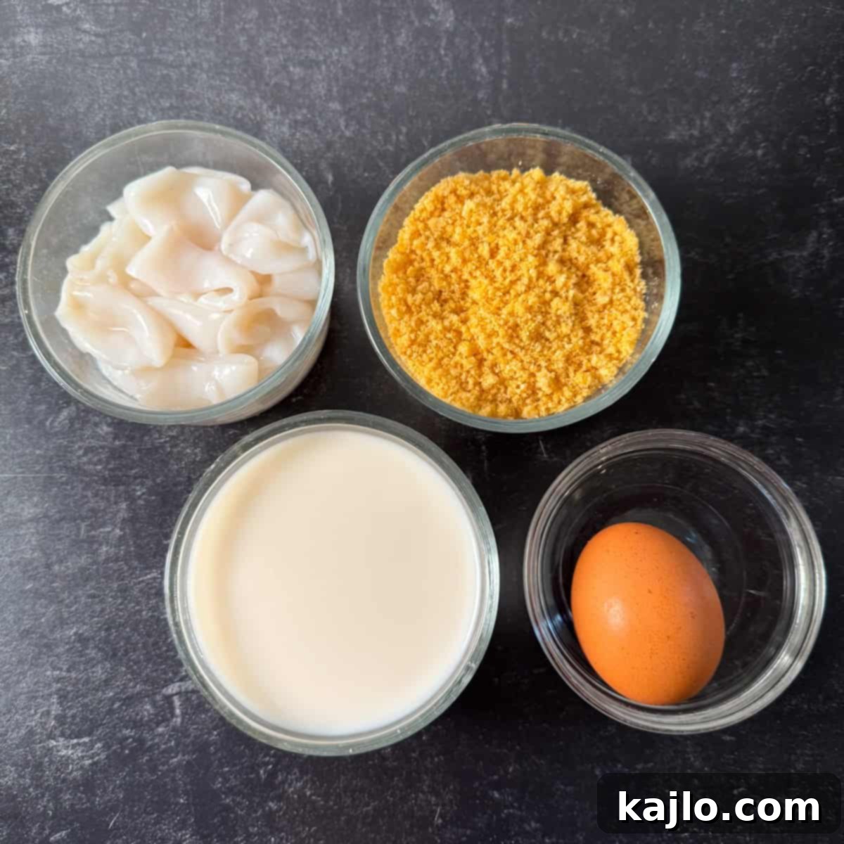 Pork Rind Crusted Air Fryer Calamari 3 Ingredients laid out for air fryer calamari, including calamari rings, buttermilk, egg, and pork panko