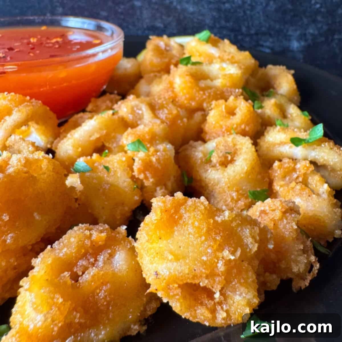 Pork Rind Crusted Air Fryer Calamari 7 Freshly air-fried squid rings, golden and crispy, ready to be served