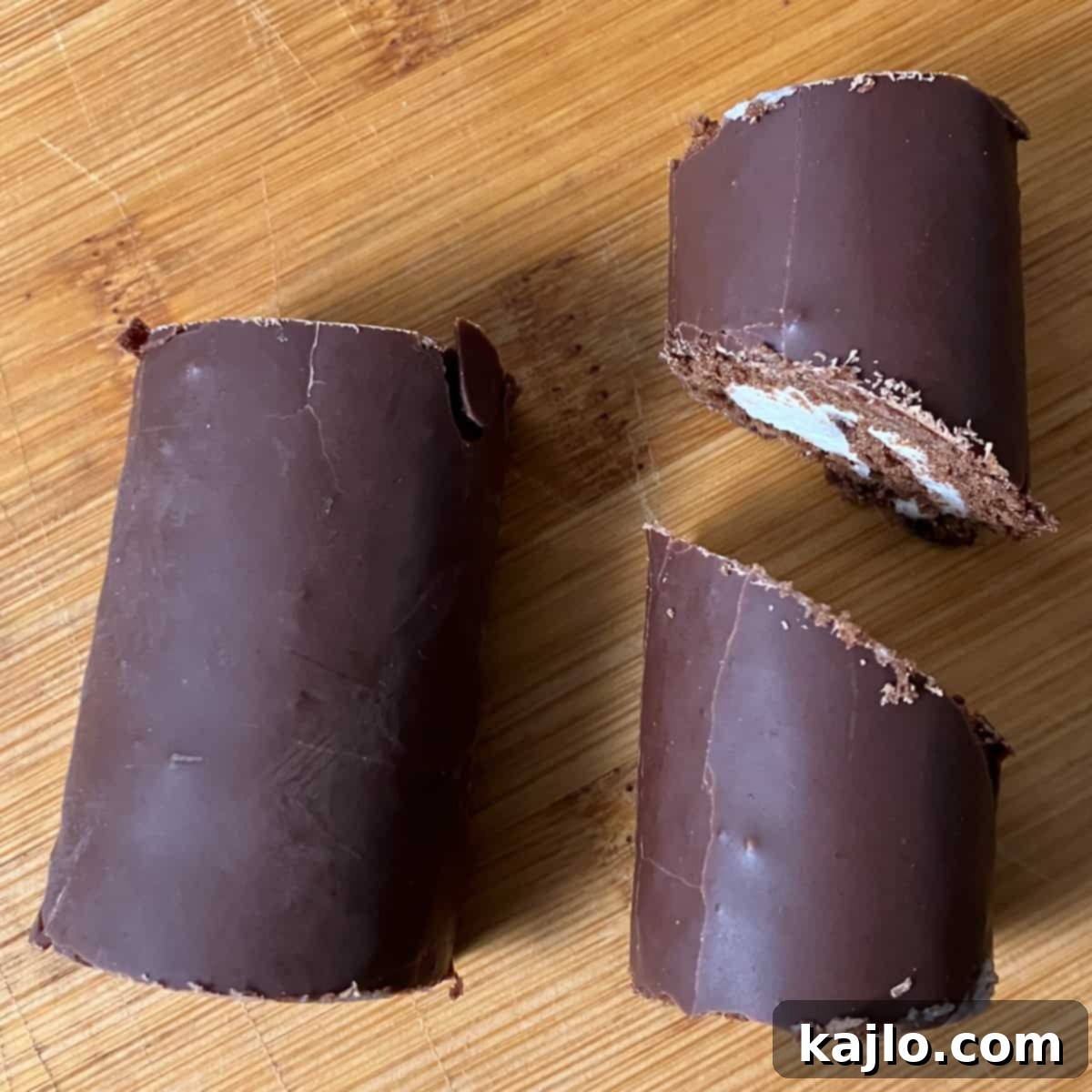 Cutting Swiss rolls for the Yule log shape, showing a diagonal cut for branches.