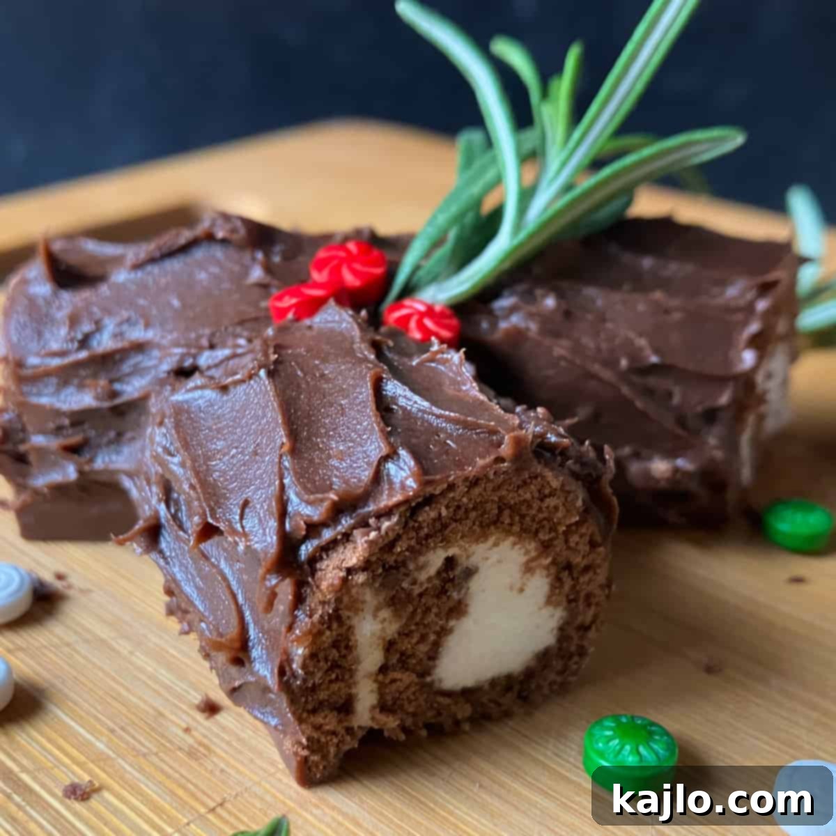 Decorated no-bake Yule log with rosemary, sprinkles, and powdered sugar.